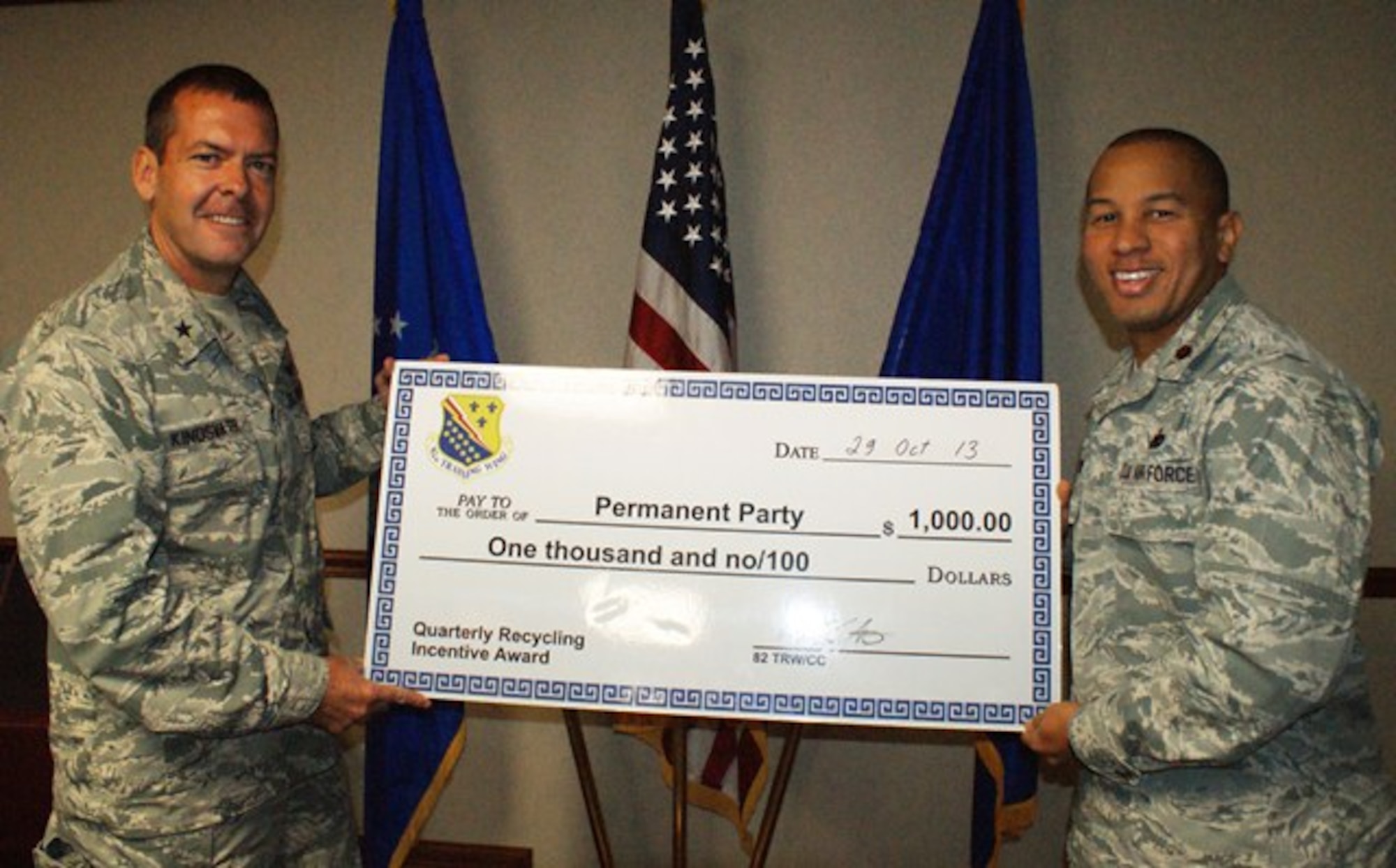 Brig Gen. Scott Kindsvater (left), 82nd Training Wing commander, congratulates 82nd Logistics Readiness Squadron commander Maj. Samuel Payne Oct. 29, 2013, after Payne accepted the FY13, 4th Quarter Recycling permanent party award on behalf of the 82nd MSG commander. The 82nd MSG collected almost 79,000 pounds of recyclables this quarter. (U.S. Air Force photo/Dan Hawkins)