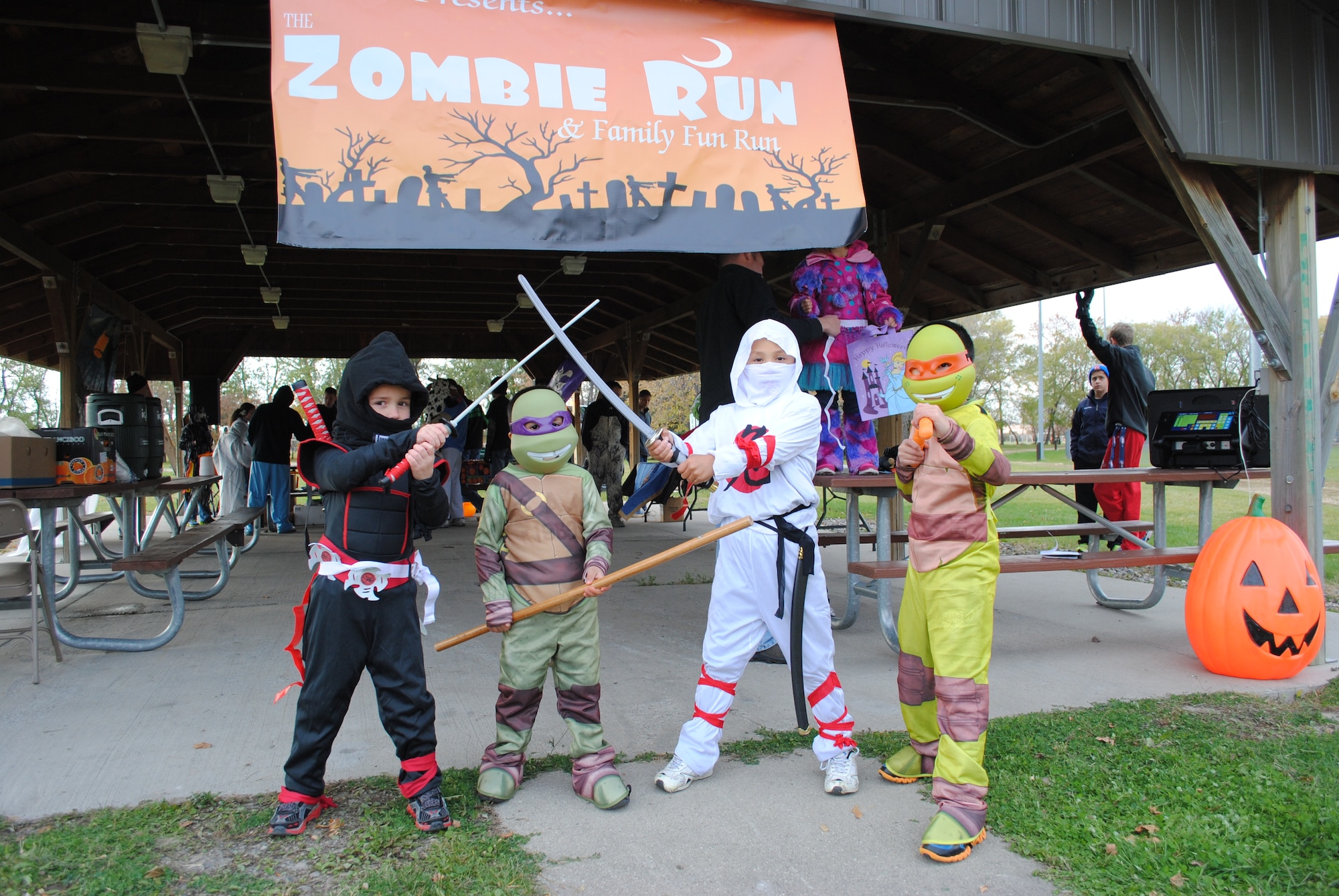 (From left) Trick-or-treaters Austin Hager, Christian Perez, Jayden Wheaton and Damian Perez pose while their parents and chaperones register them for the family fun run portion of the Zombie Run, hosted Oct. 26, 2013, by the Air Force Sergeants Association, Chapter 964, on Grand Forks Air Force Base, N.D. Children registered for the three kilometer-long family fun run could also compete in a children’s costume contest. (U.S. Air Force photo/Staff Sgt. Luis Loza Gutierrez) 