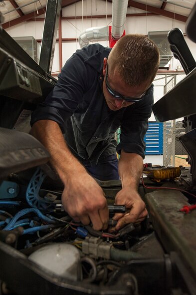 U.S. Air Force Staff Sgt. Tyler Craig, 23d Logistics Readiness Squadron mechanical analyst technician journeyman, repairs wiring on a government forklift at Moody Air Force Base, Ga., Oct. 28, 2013. Craig inspects using a voltmeter to ensure wires will not provide resistance to the engine starter. (U.S. Air Force photo by Airman Dillian Bamman/Released)