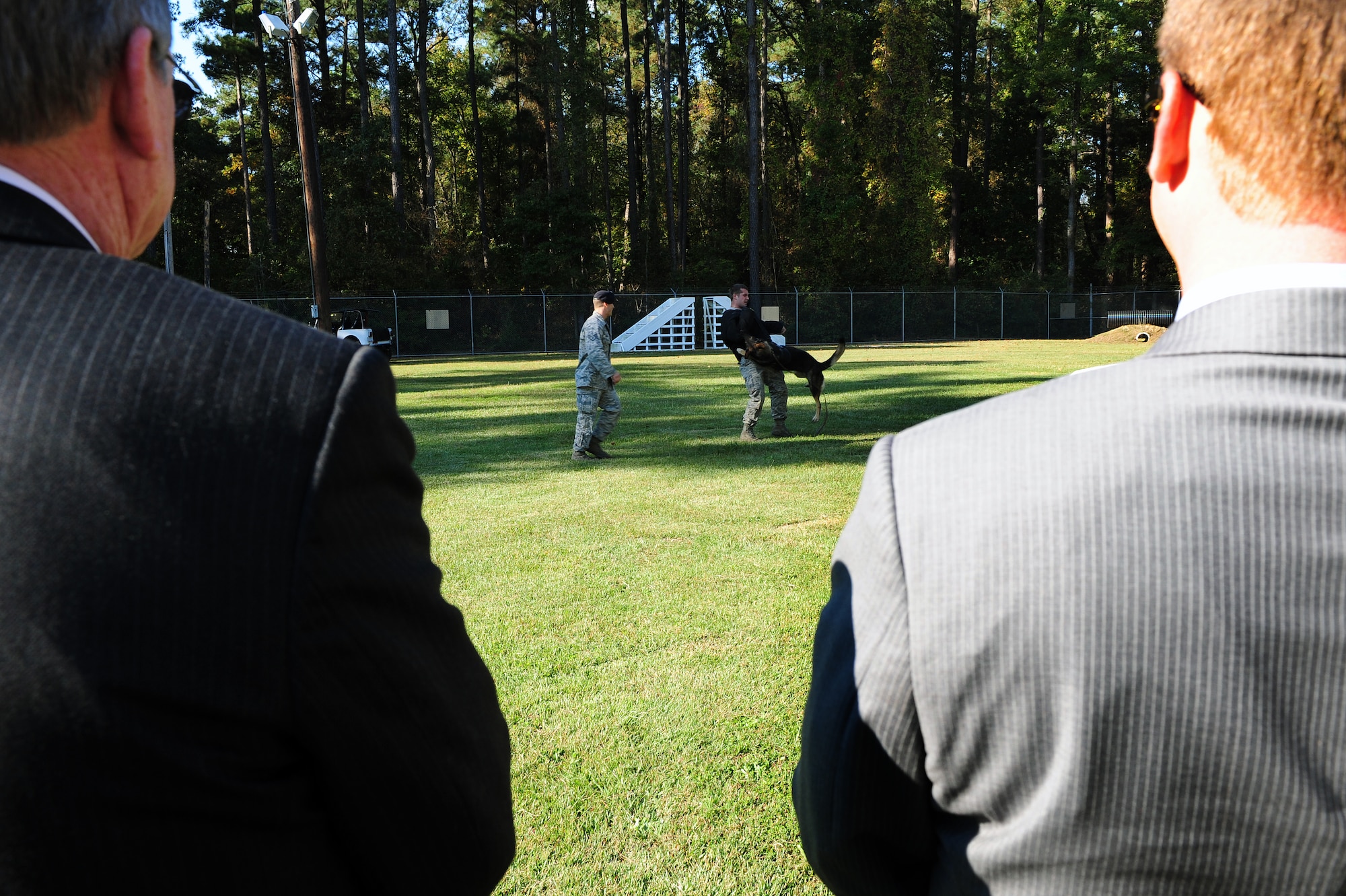 Members of the North Carolina State Legislature watch a military working dog (MWD) demonstration during a tour at Seymour Johnson Air Force Base, N.C., Oct. 24, 2013. The demo showcased MWD’s actions when faced with an enemy. (U.S. Air Force photo by Airman 1st Class John Nieves Camacho) 