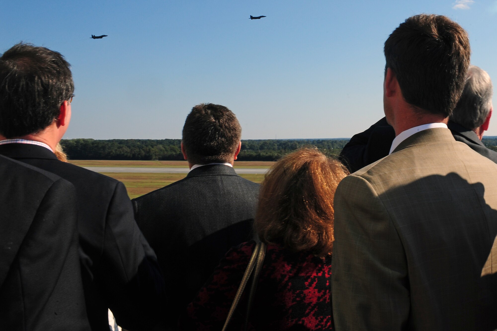 Members of the North Carolina State Legislature watch as two F-15E Strike Eagle aircraft fly over Seymour Johnson Air Force Base, N.C., Oct. 24, 2013. During the tour, they learned how the 4th Fighter Wing contributes to the Air Force mission. (U.S. Air Force photo by Airman 1st Class John Nieves Camacho)