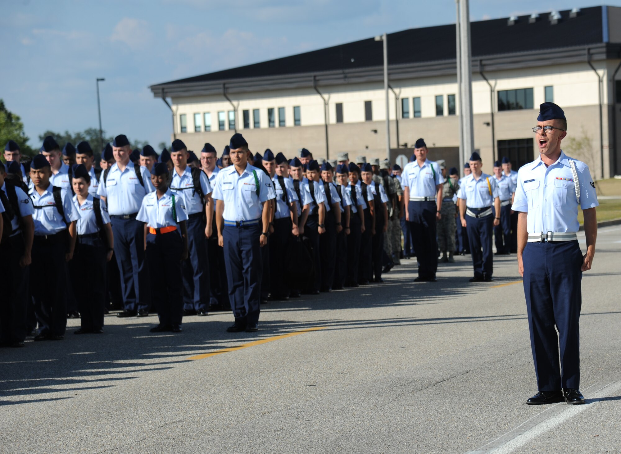 Airman Jared Boles, 335th Training Squadron, forms up troops as they prepare to march from Wolfe Hall to the triangle area Oct. 28, 2013, Keesler Air Force Base, Miss.  He is the 81st Training Group’s Airman of the Month for September.  Boles, from Roseville, Calif., is currently training in the weather apprentice course.  The four squadrons that train nonprior service students each select one Airman to compete at a monthly group board. The Airmen respond to questions about customs and courtesies, dress and appearance, enlisted force development and current events from that week’s issue of the Keesler News.  (U.S. Air Force photo by Kemberly Groue)