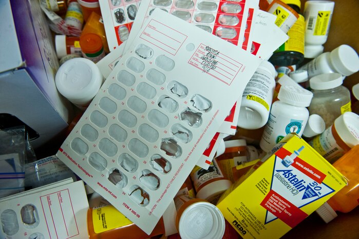 Airmen from the 99th Medical Operations Squadron Pharmacy place unused and expired medications into a box for collection for disposal at the Exchange Oct. 25, 2013, at Nellis Air Force Base, Nev. Unused and expired medications were turned in for proper disposition by the Air Force Office of Special Investigations detachment on Nellis AFB and the Las Vegas Drug Enforcement Agency. It is mandatory for expired medications to be disposed of every six months. (U.S. Air Force photo/Senior Airman Brett Clashman)