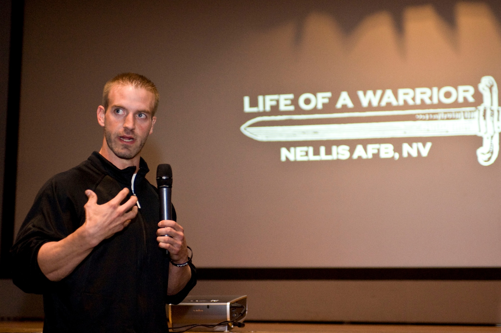Ben Booker, Second Chance Lifestyle founder, speaks during a 99th Air Base Wing Commander's Call at the base theater Oct. 21, 2013, at Nellis Air Force Base, Nev. Booker talked about what life of a warrior means to him, and how physical fitness is a key part of the four pillars of Comprehensive Airmen Fitness. (U.S. Air Force photo by Senior Airman Matthew Lancaster)