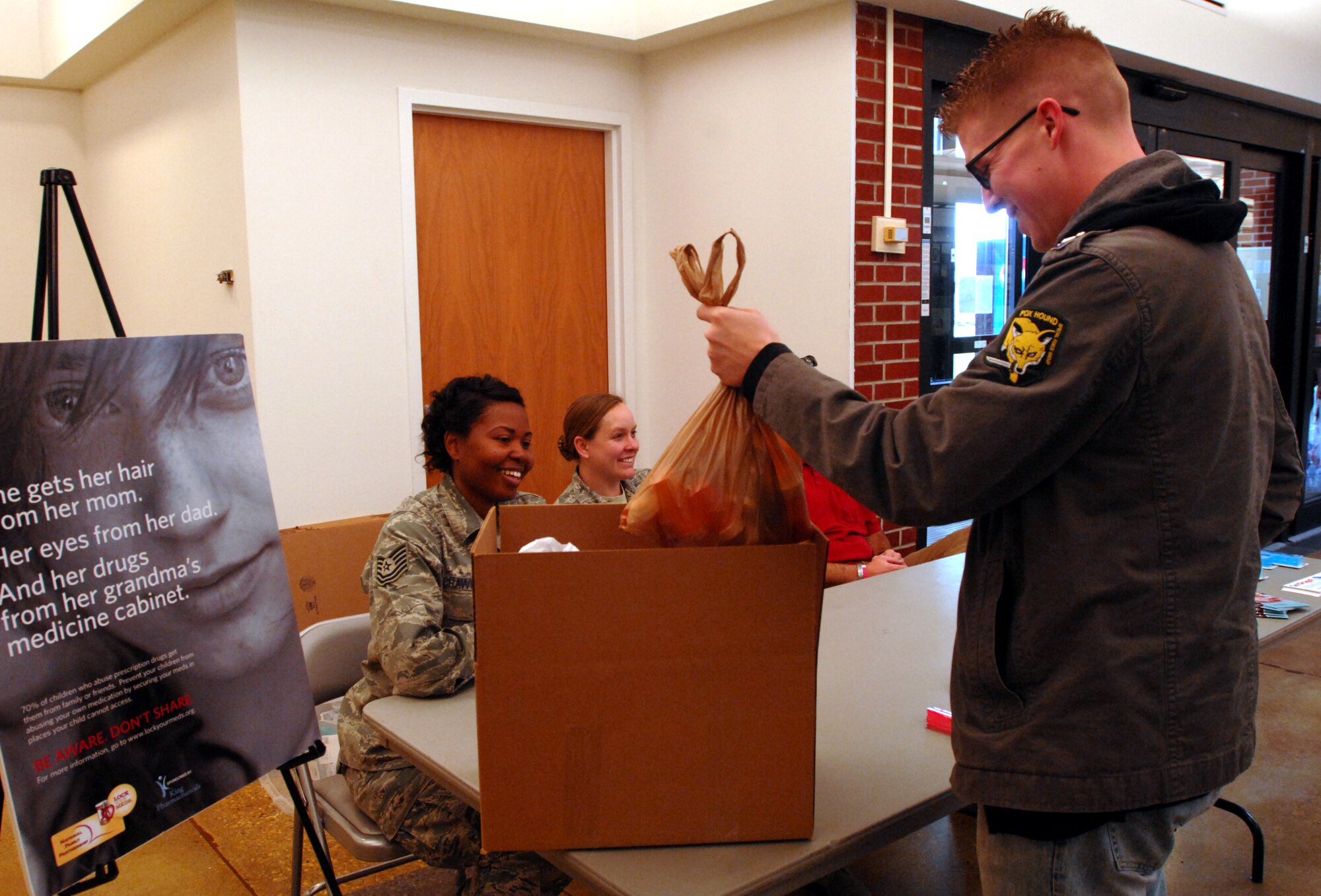 Staff Sgt. Brian Davis, 319th Civil Engineer Squadron unit deployment manager, turns in a bag of prescription and over-the-counter medications Oct. 26, 2013, at the Base Exchange on Grand Forks Air Force Base, N.D. Oct. 26 was designated as Drug Take-Back Day for the base, where base employees and residents could turn in their expired and unused drugs for disposal. (U.S. Air Force photo/Staff Sgt. Susan L. Davis)