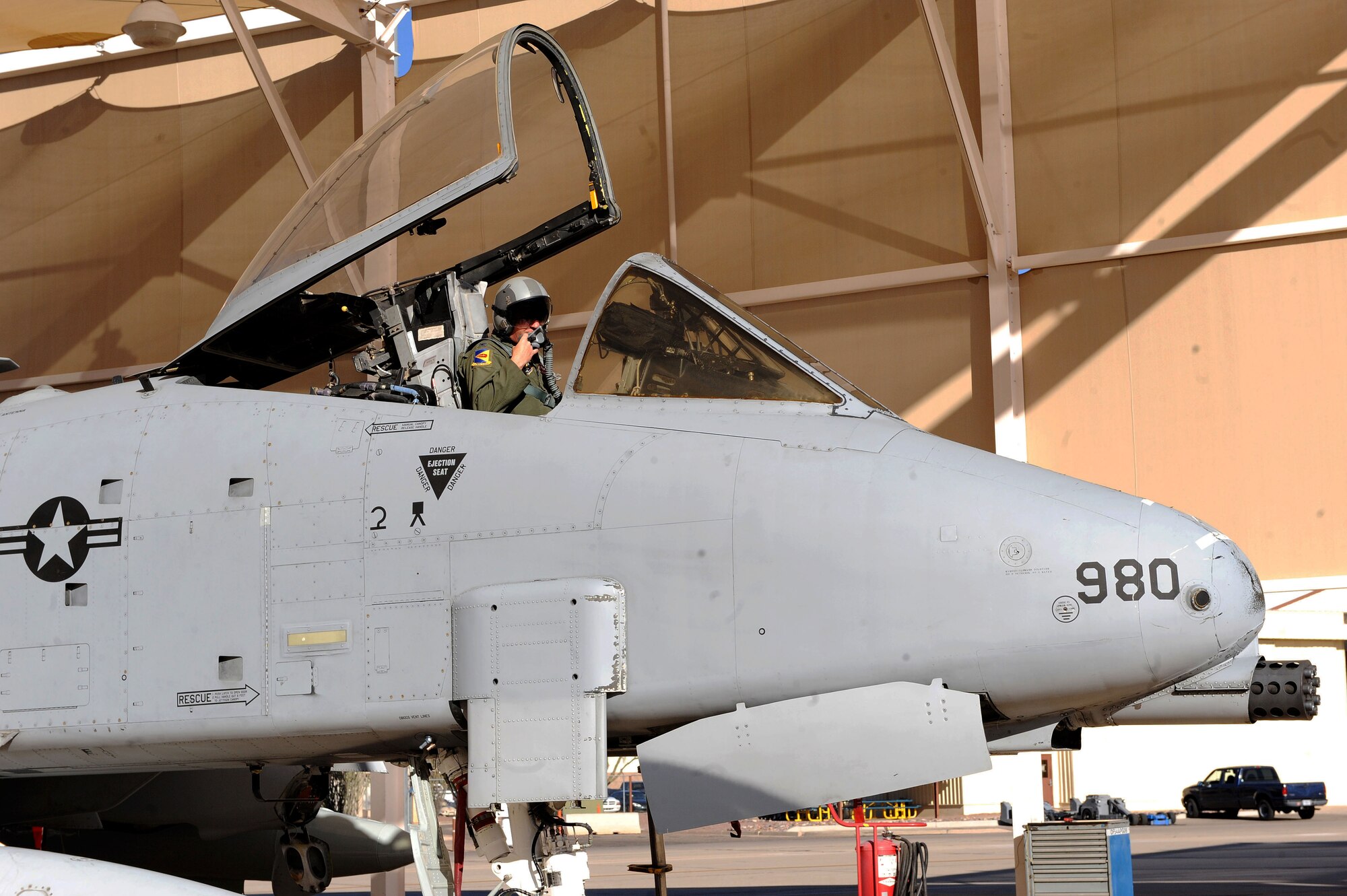 U.S. Air Force Col. Phil Wielhouwer, 355th Operations Group commander, communicates with maintainers as he sits in an A-10 Thunderbolt II at Davis-Monthan Air Force Base, Ariz., Oct. 25, 2013. Wielhouwer and four other D-M pilots traveled to Moody AFB, Ga., to bring back five A-10s. These planes were flown to Moody from Spangdahlem Air Base, Germany, after the 81st Fighter Squadron there was inactivated. (U.S. Air Force photo by Airman 1st Class Saphfire Cook/Released) (cropped)