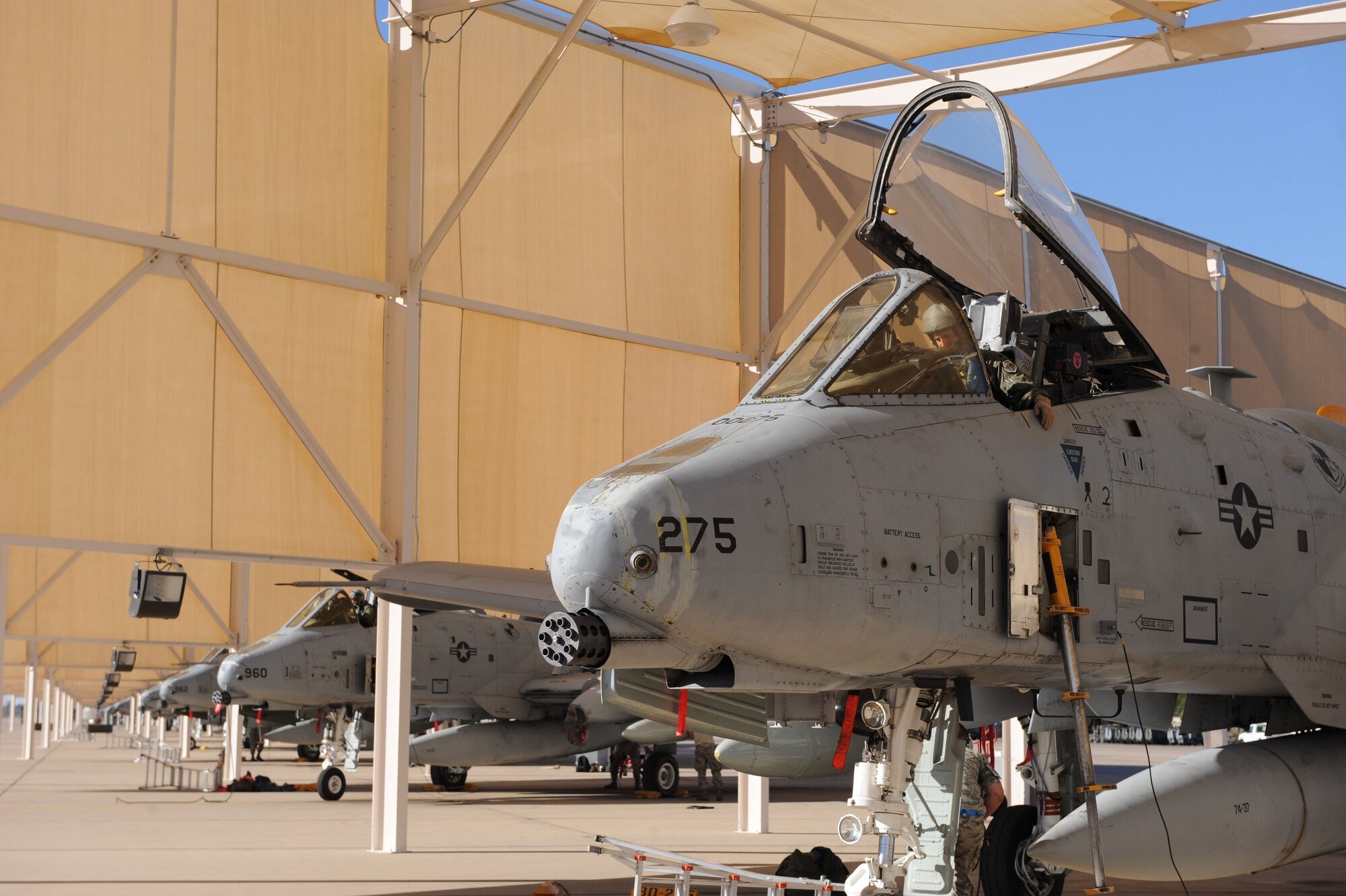 U.S. Air Force Lt. Col. Michael Curley, 357th Fighter Squadron commander, sits in an A-10 Thunderbolt II that is parked beneath a sunshade at Davis-Monthan Air Force Base, Ariz., Oct. 25, 2013. These planes were flown from Spangdahlem Air Base, Germany, as part of an aircraft replenishing effort for the 354th FS. (U.S. Air Force photo by Airman 1st Class Saphfire Cook/Released) 