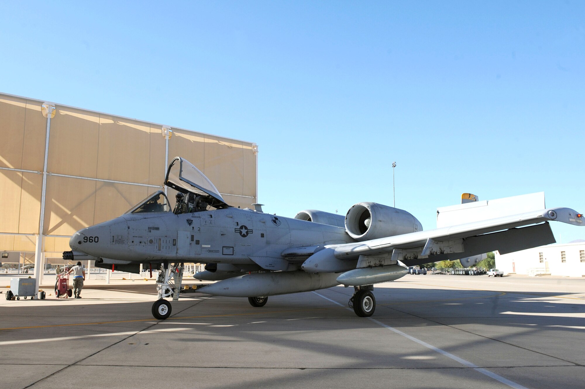 A U.S. Air Force A-10 Thunderbolt II pulls beneath a sunshade at Davis-Monthan Air Force Base, Ariz., Oct. 25, 2013. Pilots flew five A-10s from Spangdahlem Air Base, Germany, to the flightline here to become part of the 354th Fighter Squadron. The planes came from the 81st FS in Spangdahlem after the unit was inactivated. (U.S. Air Force photo by Airman 1st Class Saphfire Cook/Released) (cropped)