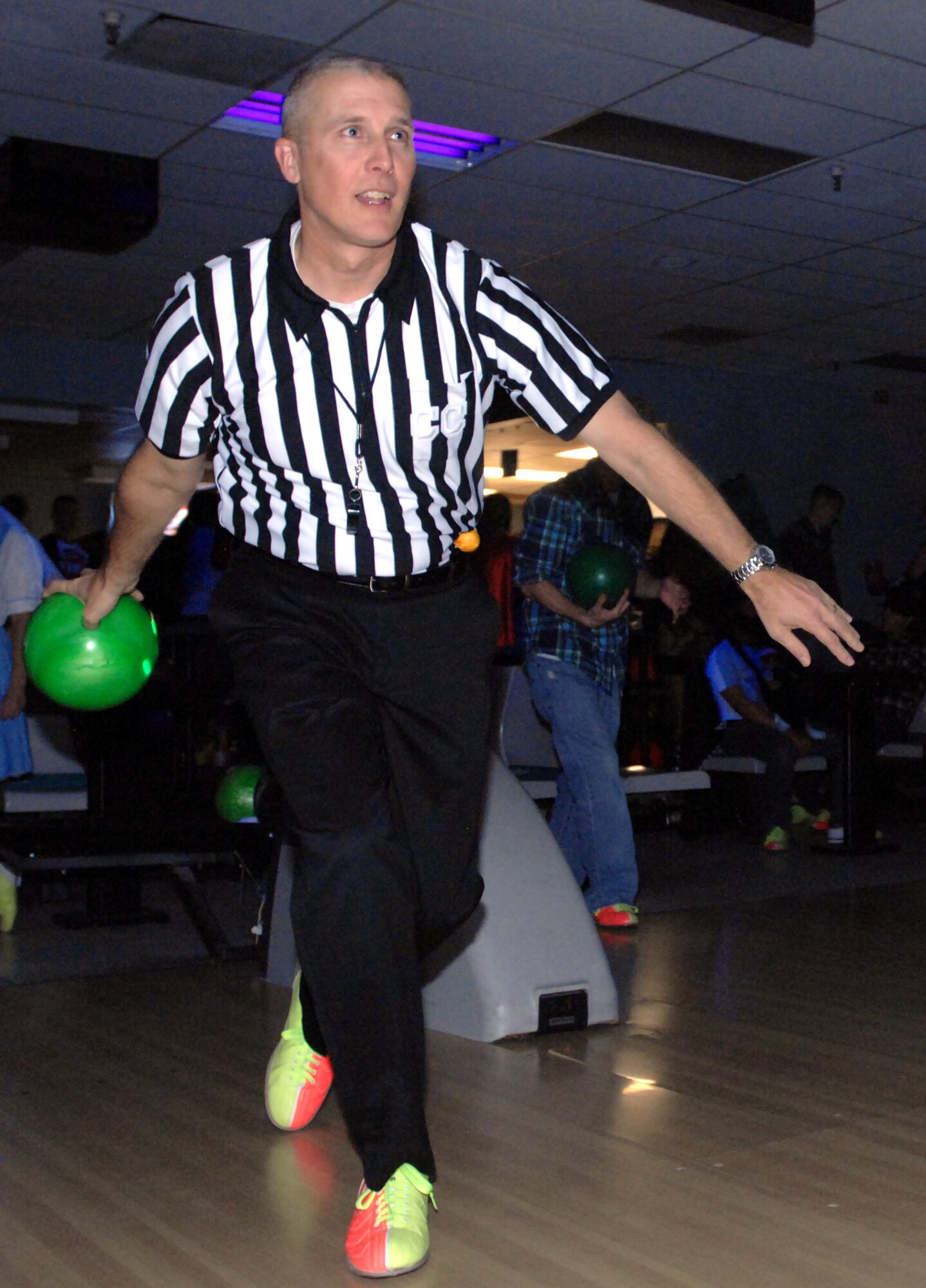 Col. Paul Bauman, 319th Air Base Wing commander, bowls in a referee costume Oct. 25, 2013, at the Dakota Lanes Bowling Alley Monster Bowling event on Grand Forks Air Force Base, N.D. The event offered family-friendly costume bowling and a costume contest. (U.S. Air Force photo/Staff Sgt. Susan L. Davis)