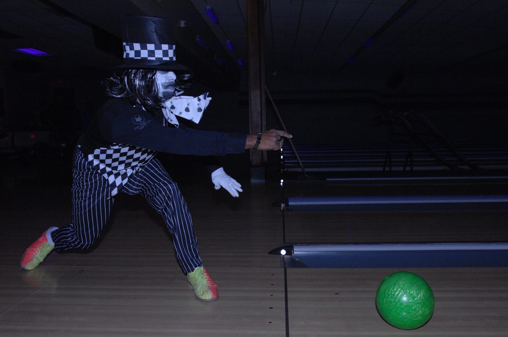 Senior Airman Jeremy Alberty, 319th Logistics Readiness Squadron, bowls as the Mad Hatter Oct. 25, 2013, during Monster Bowling at the Dakota Lanes Bowling Alley on Grand Forks Air Force Base, N.D. The event also featured a costume contest, which Alberty won. (U.S. Air Force photo/Staff Sgt. Susan L. Davis)
