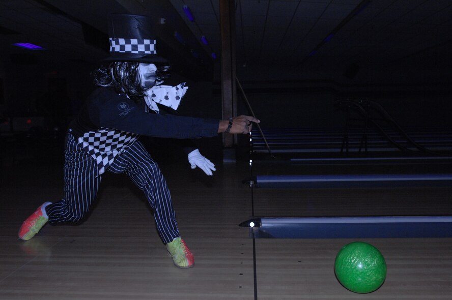 Senior Airman Jeremy Alberty, 319th Logistics Readiness Squadron, bowls as the Mad Hatter Oct. 25, 2013, during Monster Bowling at the Dakota Lanes Bowling Alley on Grand Forks Air Force Base, N.D. The event also featured a costume contest, which Alberty won. (U.S. Air Force photo/Staff Sgt. Susan L. Davis)