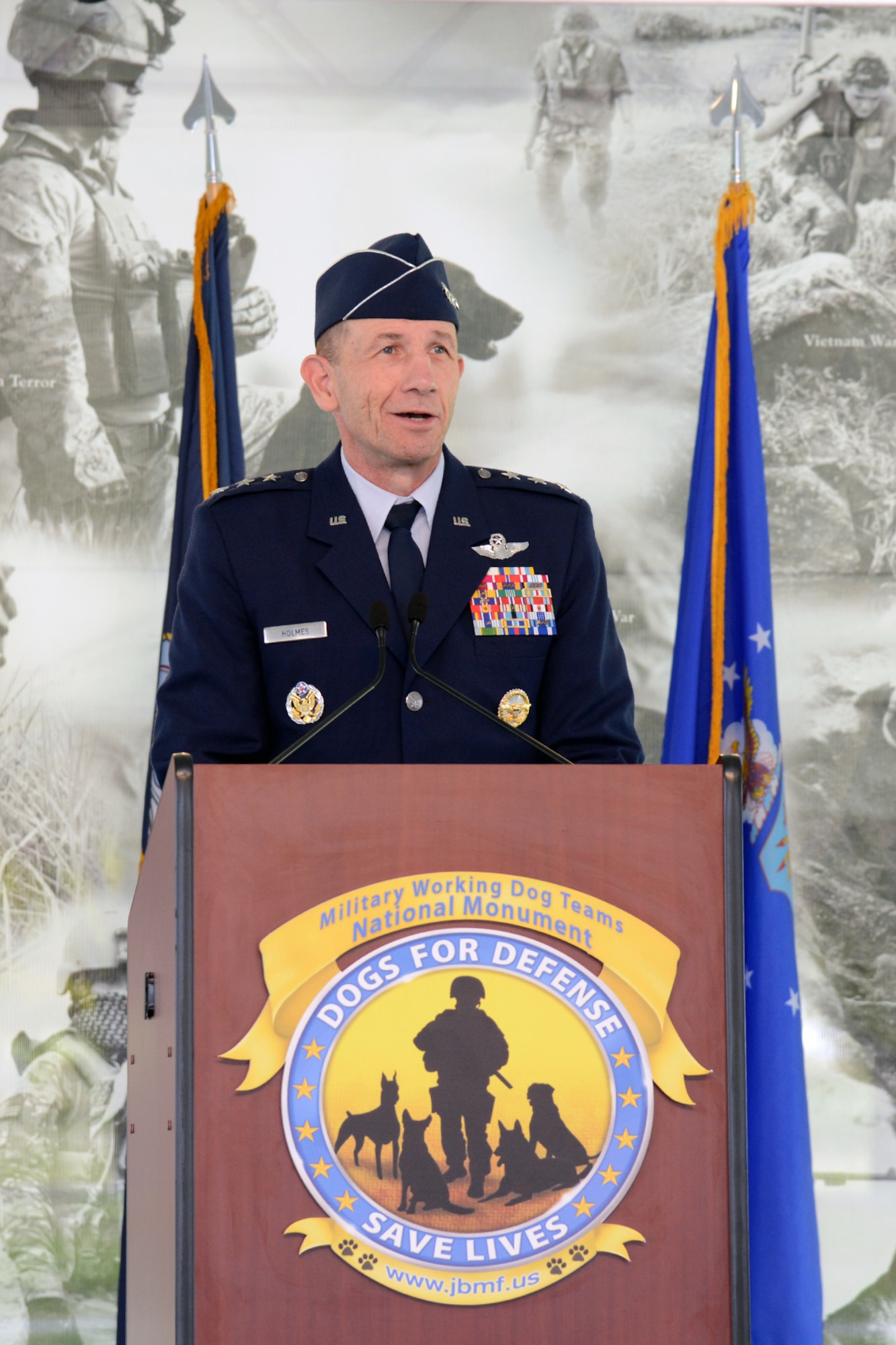 JOINT BASE SAN ANTONIO-LACKLAND, Texas -- Lt. Gen. James Holmes Vice Commander, Air Education and Training Command, Joint Base San Antonio-Randolph, speaks at the U.S. Military Working Dog Teams National Monument dedication ceremony Oct. 28 at Joint Base San Antonio-Lackland. JBSA-Lackland is the home to the Department of Defense Military Working Dog Program and is where the U.S. Armed Forces has been training its military working dog teams since 1958. It is the world's largest training center for military dogs and handlers and is also home to the largest veterinary hospital for military working dogs.(U.S. Air Force photo by Ben Faske) 
