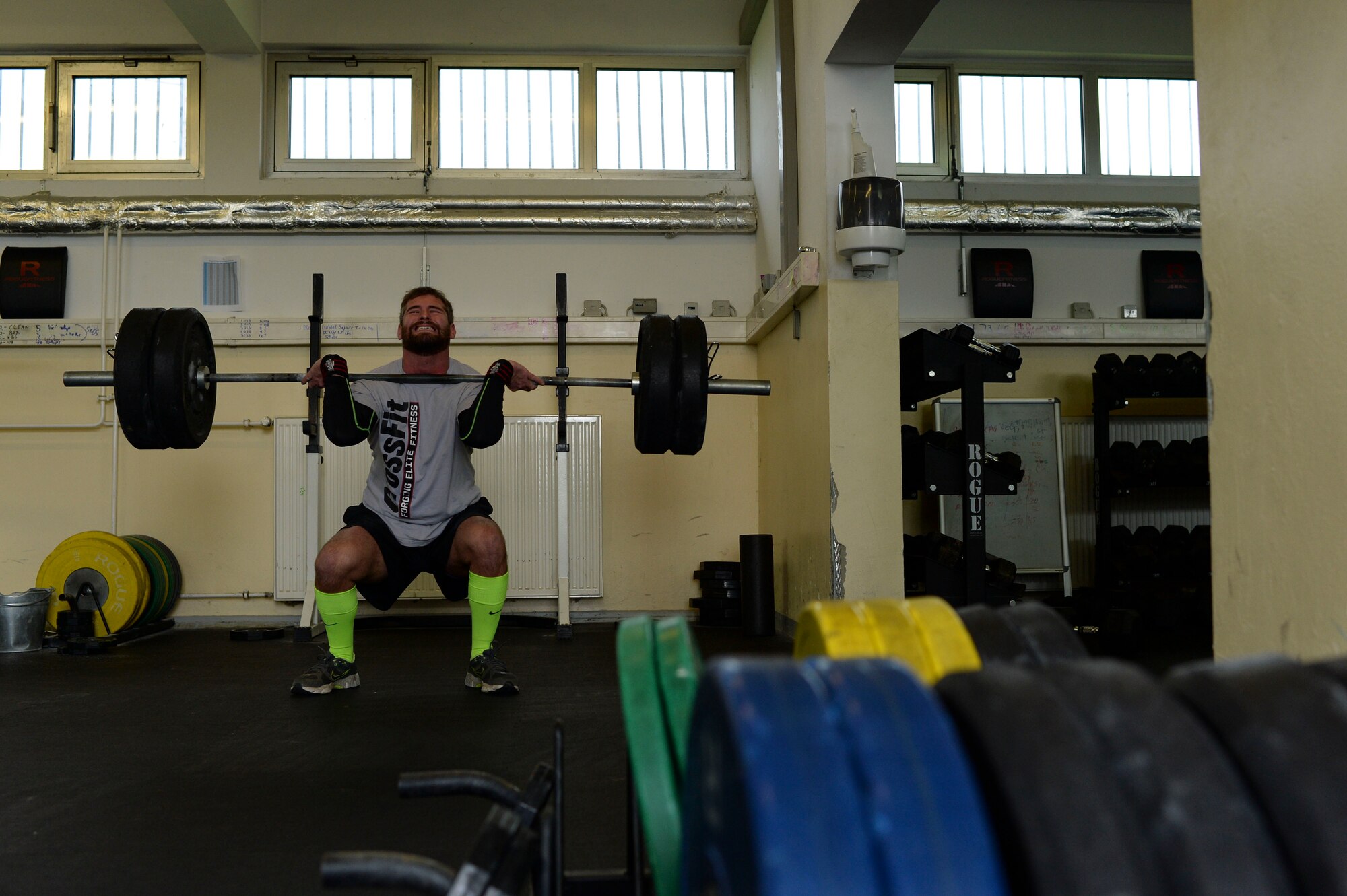 SPANGDAHLEM AIR BASE, Germany--Elliot Curtis, a 52nd Force Support Squadron Eifel Arms Inn shuttle driver from Fort Walton Beach, Fla., lifts weights inside the bases' war fit gym Oct. 23, 2013. After more than three years and major shoulder surgery Curtis is back playing rugby in his first year as the captain of the University of Trier rugby team. (U.S. Air Force photo by Senior Airman Rusty Frank/Released)