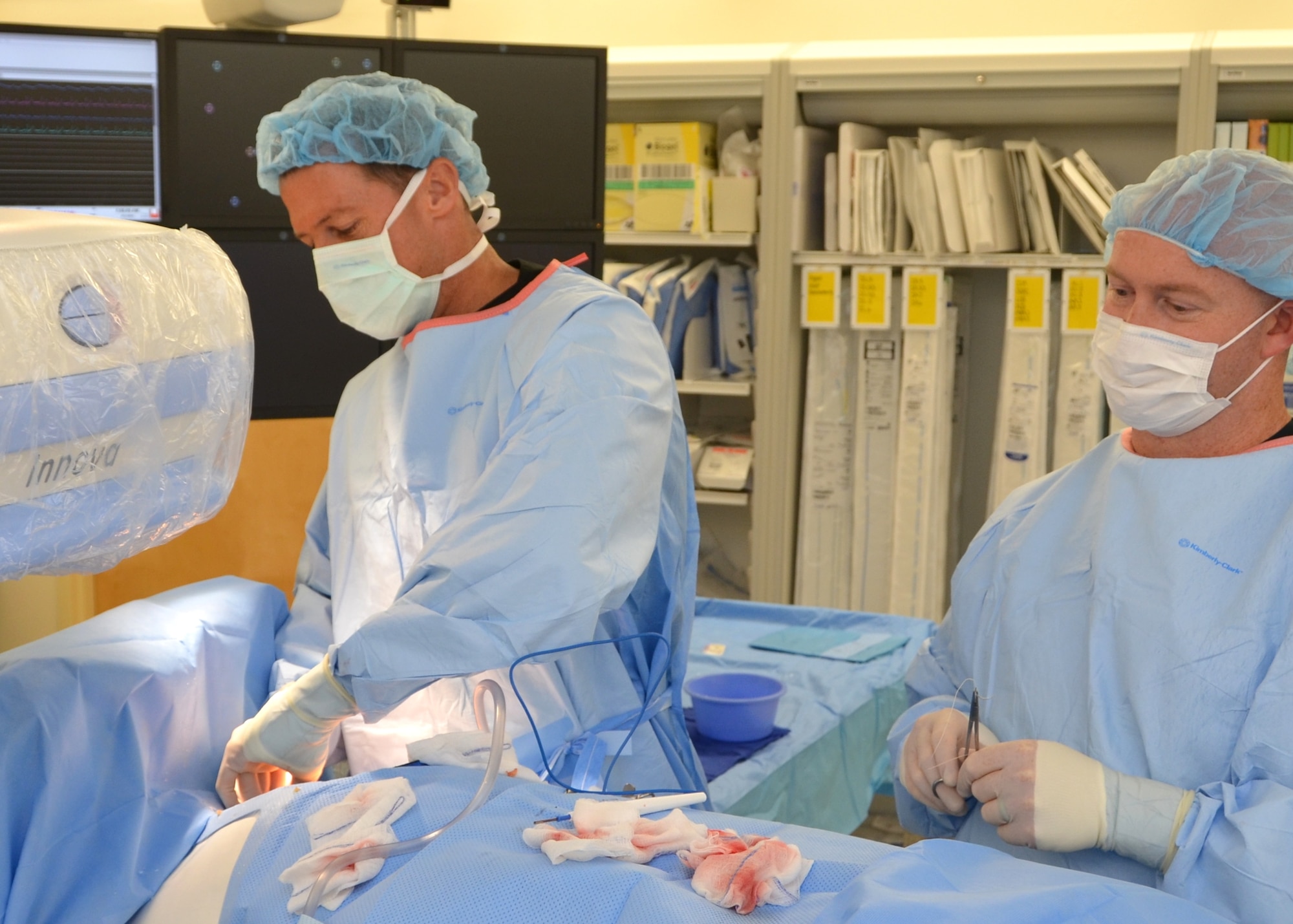 Lt. Col. (Dr.) Steve Kindsvater inserts a monitor just under the skin in a study volunteer’s chest area during a Sept. 17 procedure.  Cath lab technician Adam Hudson, assists.  Hudson manages the Keesler catheterization lab. (U.S. Air Force photo by Steve Pivnick)