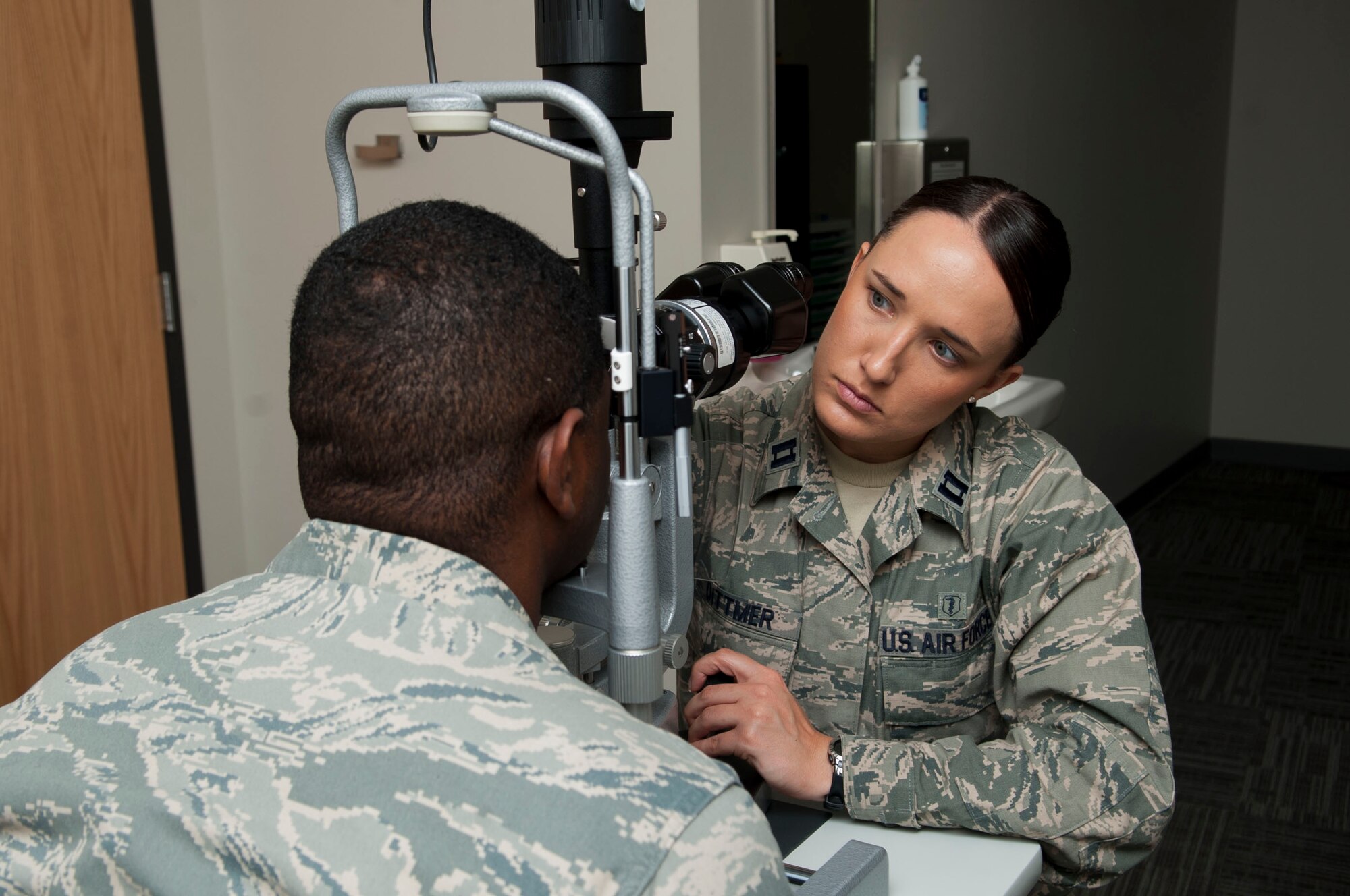 U.S. Air Force Capt. (Dr.)Kaylaen Dittmer, 23d Medical Group optometrist, uses a slit lamp to evaluate a patient’s eyes at Moody Air Force Base, Oct. 22, 2013. Slit lamps give the optometrist a magnified view of the internal and external portions of the eye. (U.S. Air Force photo by Airman  1st Class Sandra Marrero/Released)
