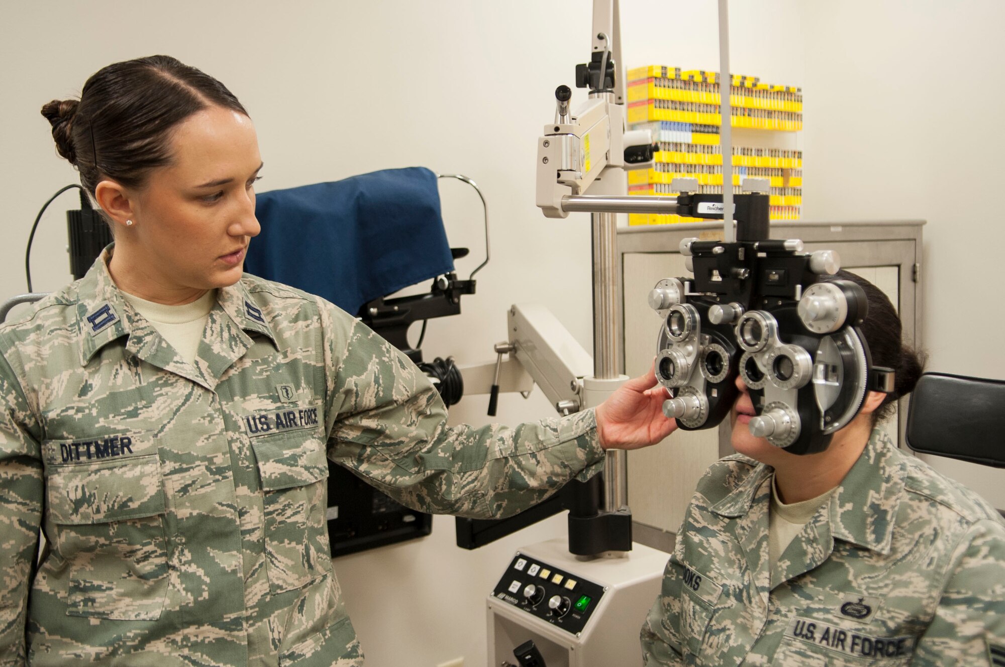 U.S. Air Force Capt. (Dr.) Kaylaen Dittmer, 23d Medical Group optometrist, uses a phoropter at Moody Air Force Base, Oct. 22, 2013. The phoropter contains different lenses and helps determine what prescription a patient needs. (U.S. Air Force photo by Airman 1st Class Sandra Marrero/Released) 
 
