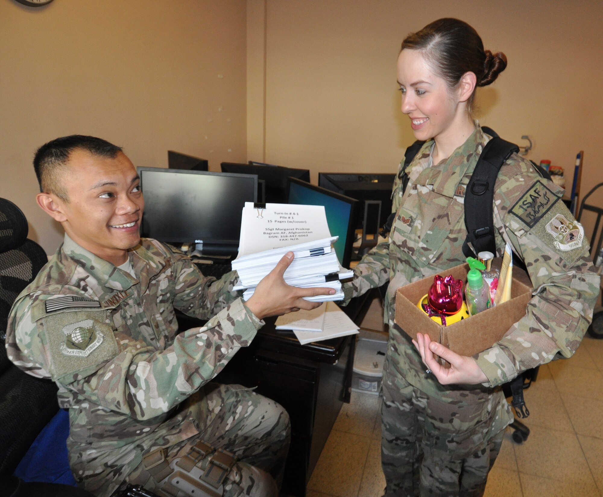 Staff Sgt. Ariel Hunsuckle, who hails from Yigo, Guam, replaces his wife Staff Sgt. Margaret Prokop, a native of Bolton, Conn., and both deployed from Nellis Air Force Base, Nev., as the 455th Air Expeditionary Wing financial management budget technician Oct. 28, 2013 on Bagram Airfield, Afghanistan. (U.S. Air Force photo/Tech. Sgt. Rob Hazelett)