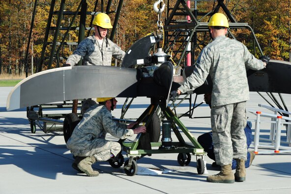 Airmen from the 86th Aircraft Maintenance Squadron remove a propeller from a C-130J Super Hercules while participating in a theater security cooperation event, Oct. 22, 2013, at Powidz Air Transport Base, Poland. Airmen from the 86th AMXS are here to ensure the aircraft are properly maintained and mission ready. (U.S. Air Force photo/Senior Airman Hailey Haux)