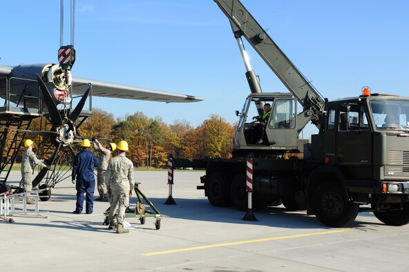 Airmen from the 86th Maintenance Squadron work with their Polish counterparts to remove a propeller from a C-130J Super Hercules during a theater security cooperation event, Oct. 22, 2013, at Powidz Air Transport Base, Poland. Airmen from the 86th AMXS were able to train and learn with Polish service members during the event. (U.S. Air Force photo/Senior Airman Hailey Haux)