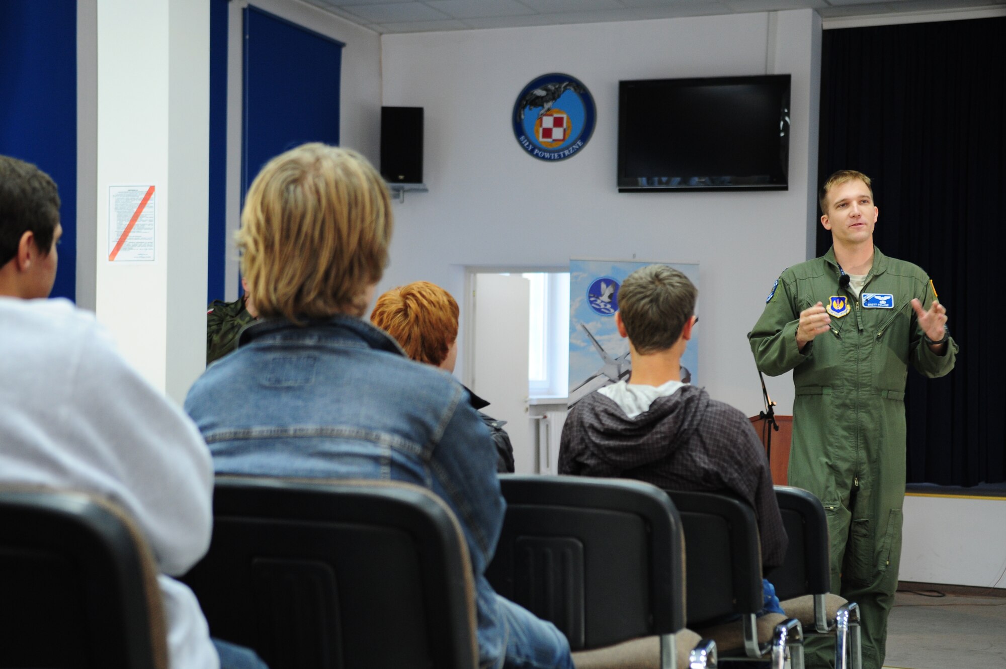 Capt. Brett Polage, 37th Airlift Squadron pilot, talks to students from the local high school about the partnerships of the U.S. and Polish air forces, Oct. 22, 2013, Powidz Air Transport Base, Poland. During the community event, Students were able to ask questions about flying and life in America. (U.S. Air Force photo/Senior Airman Hailey Haux)