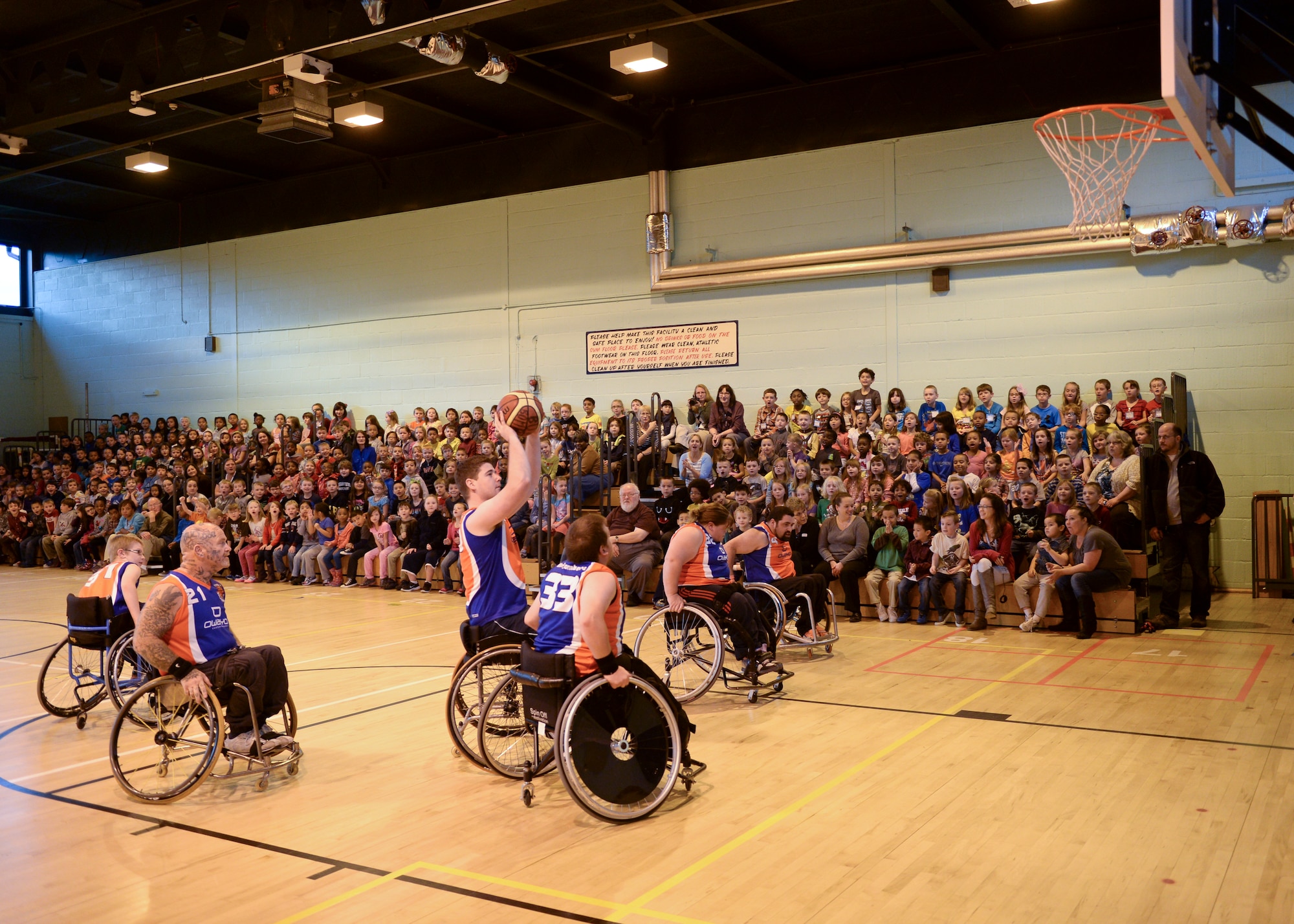 The Bury Bombers display their wheelchair basketball skills during an exhibition match at Lakenheath Elementary School on Royal Air Force Lakenheath, England, Oct. 22, 2013. During the Bombers’ visit, kids gain knowledge in the sport of wheelchair basketball while also being instilled with respect of persons with disabilities. (U.S. Air Force photo by Airman 1st Class Nigel Sandridge/Released) 