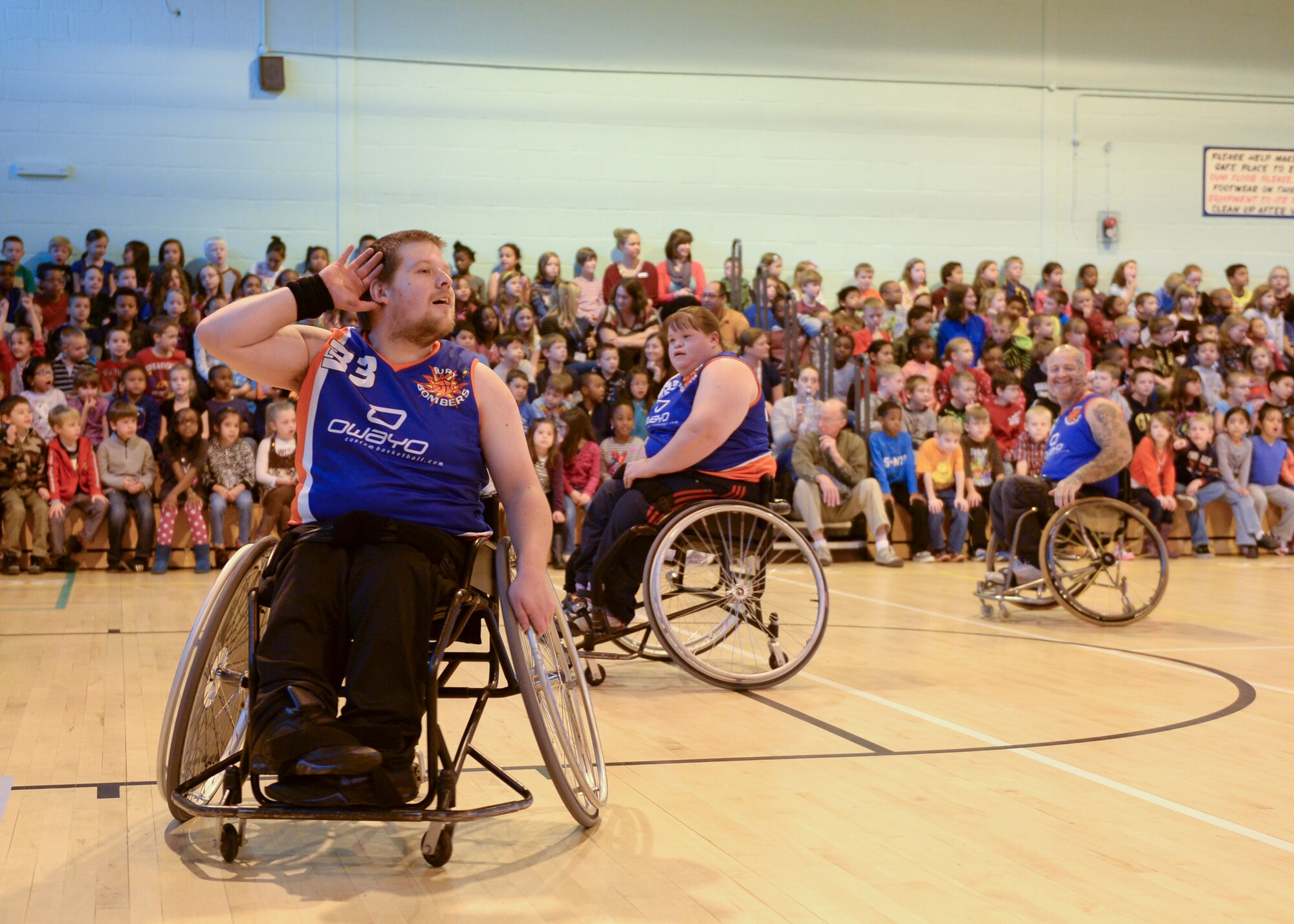 The Bury Bombers amp up the crowds with team chants prior to the exhibition match held on Royal Air Force Lakenheath, England, Oct. 22, 2013. During the Bombers’ visit, kids gain knowledge in the sport of wheelchair basketball while also being instilled with respect of persons with disabilities. (U.S. Air Force photo by Airman 1st Class Nigel Sandridge/Released) 