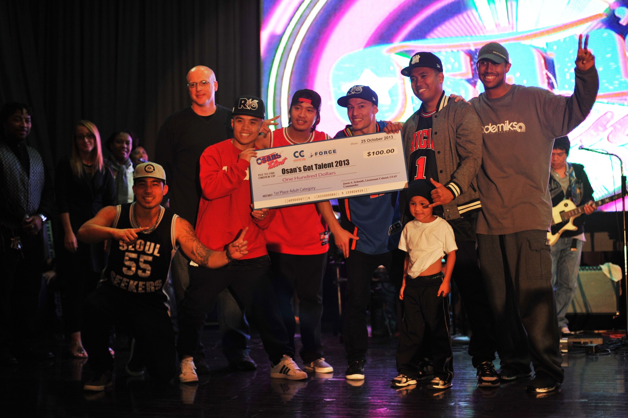 The Osan “B-Boys” break dance group, pose with the first place prize for the adult’s category at the ‘Osan’s got talent’ contest at Osan Air Base Republic of Korea, Oct. 26, 2013. Contestants went up against 17 other competing acts. (U.S. Air Force photo/Staff Sgt. Emerson Nuñez)