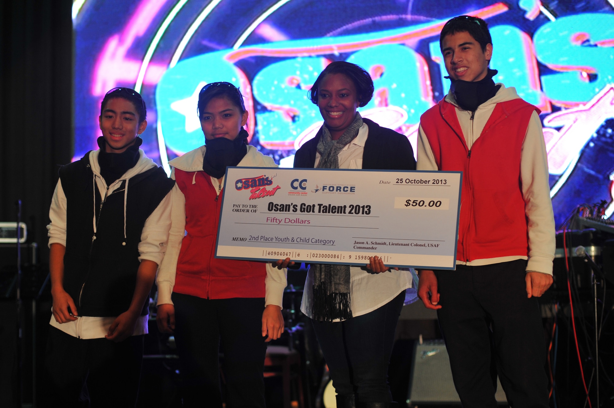 Albert Bontilao, far left, Raquel Bontilao, second from left, and Delano Hurst, right, pose with the second place prize for the children’s category at the ‘Osan’s got talent’ contest at Osan Air Base Republic of Korea, Oct. 26, 2013. Contestants ranged in age from four to 40, representing the entire community. (U.S. Air Force photo/Staff Sgt. Emerson Nuñez)