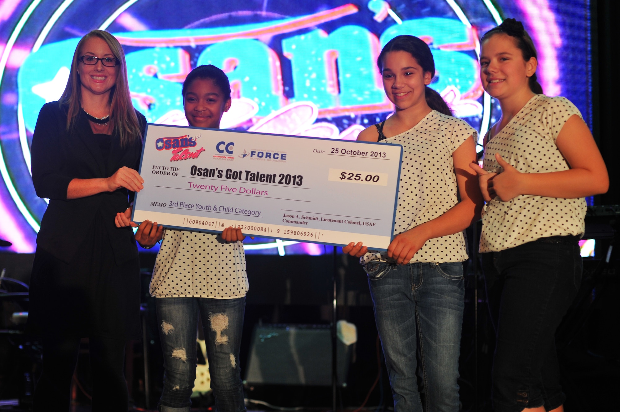The dance group “Spices” pose for a photo with the third place prize for the children’s category at the ‘Osan’s got talent’ contest at Osan Air Base Republic of Korea, Oct. 26, 2013. More than 350 family members and friends cheered on their favorite contestants as they performed magic acts, sang, and danced the night away. (U.S. Air Force photo/Staff Sgt. Emerson Nuñez)