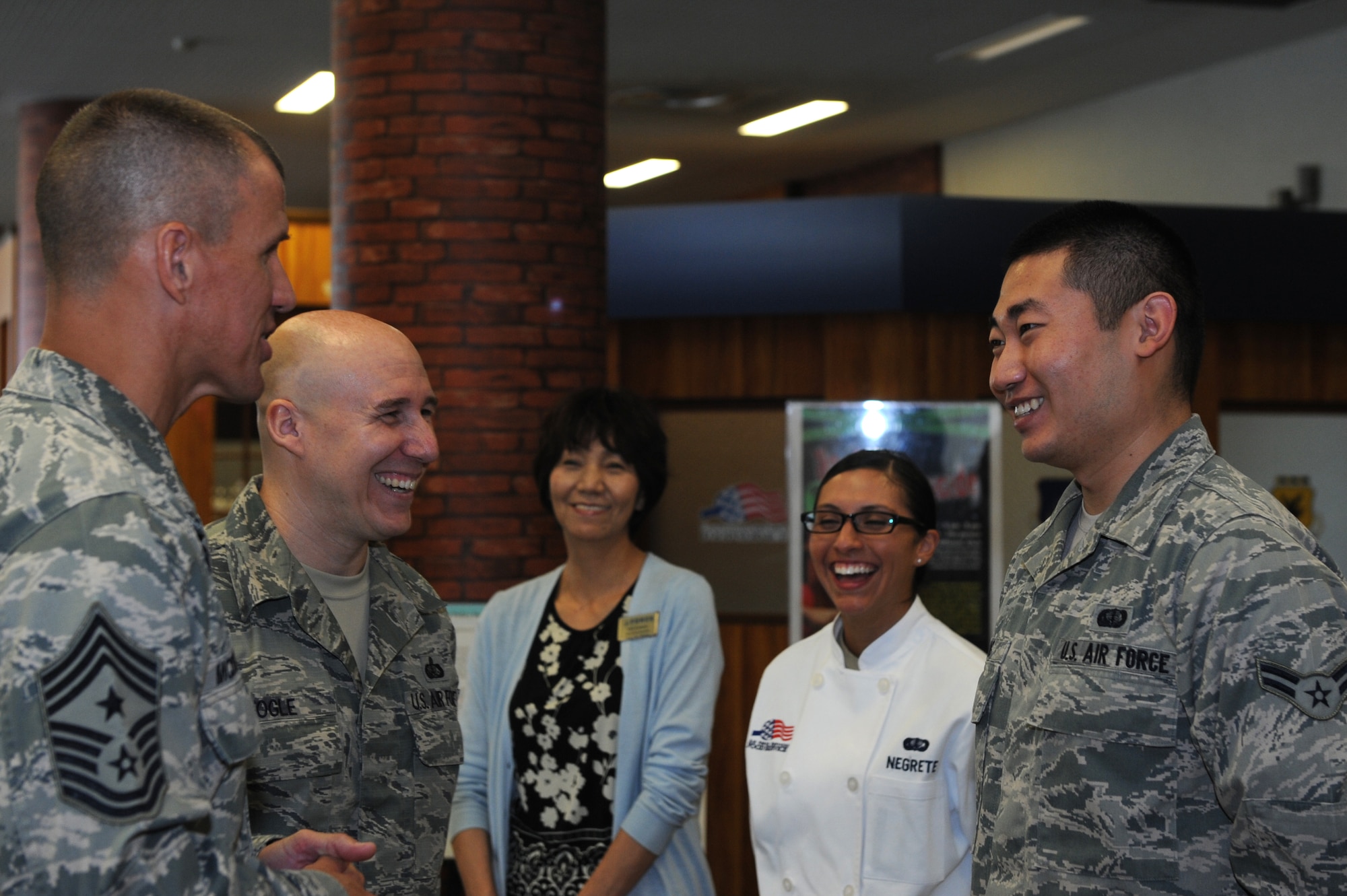 U.S. Air Force Chief Master Sgt. Steve McDonald, Pacific Air Forces command chief, greets Airman 1st Class Fanyu Meng, 18th Force Support Squadron food service shift worker, during a visit to the Marshall Dining Facility on Kadena Air Base, Japan, Oct. 28, 2013. McDonald asked Airmen what they’d change in today’s Air Force and met with dining facility personnel, who serve four meals to approximately 1,200 service members daily. (U.S. Air Force photo by Airman 1st Class Hailey R. Davis)