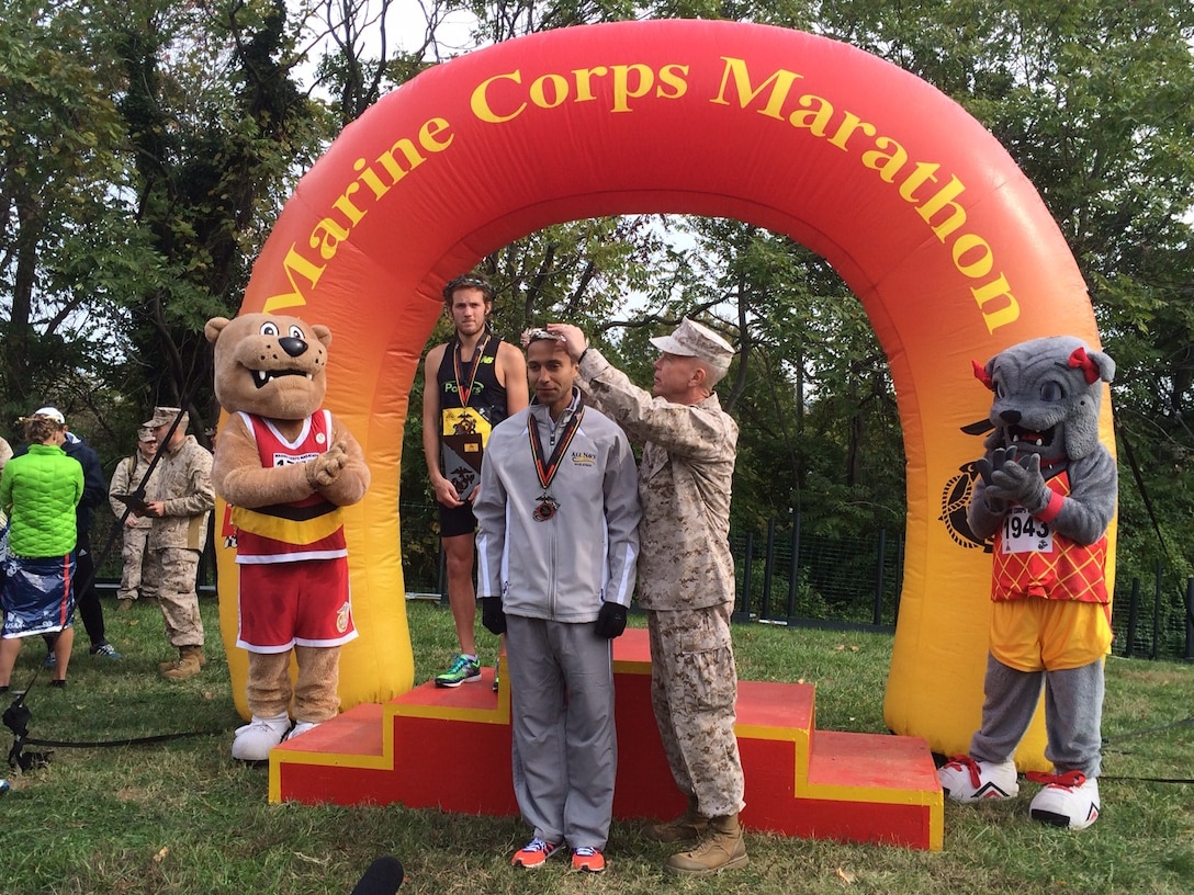 Commandant of the Marine Corps, Gen James Amos, places the silver crown on Coast Guard LT Patrick Fernandez, Yorktown, VA competes with the All-Navy Marathon Team with a time of 2:22:52.  Fernandez finished 2nd overall at the Marine Corps Marathon and places 1st in the Armed Forces Marathon Mens Championship