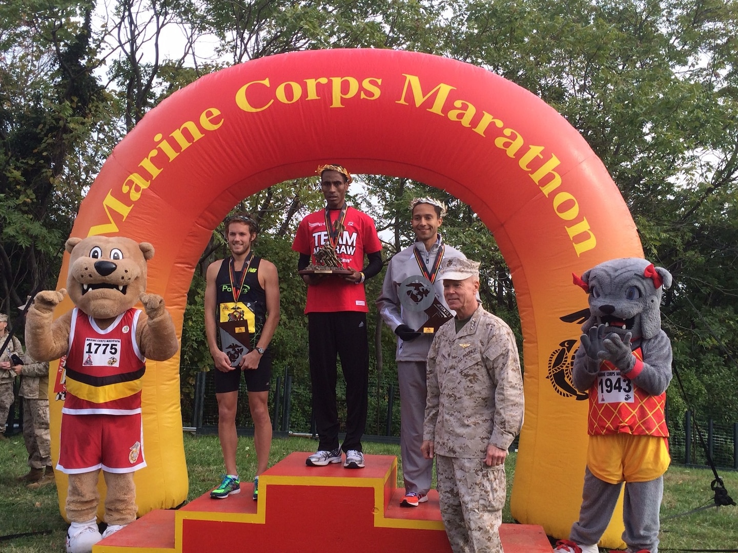Commandant of the Marine Corps, General Amos presents the top three finishers of the Marine Corps Marathon Mens Division.  Coast Guard LT Patrick Fernandez, Yorktown, VA competes with the All-Navy Marathon Team with a time of 2:22:52 finishes 2nd overall at the Marine Corps Marathon and places 1st in the Armed Forces Marathon Mens Championship.  First overall was Girma Bedada from Columbia, GA finished at 2:21:32 and Richard Morris from Burkeville, VA finished third with 2:24:02.  