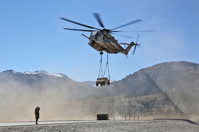 A CH-53E Super Stallion transports a HMMVW while Marines with Landing Support Company, Combat Logistics Regiment 17, 1st Marine Logistics Group, conducted helicopter support team training during Mountain Exercise 6-13, aboard Marine Corps Mountain Warfare Training Center in Bridgeport, Calif., Oct. 18, 2013. During the exercise, a small detachment of Marines from 1st MLG provided logistical support to 1st Battalion, 5th Marine Regiment, 1st Marine Division. 