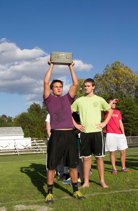 A swim-team member and student of Southwest Guilford High School presses a 30-pound ammo can above his head during a Marine Corps workout at Southwest Guilford High School in Greensboro, N.C., Oct. 23, 2013. U.S. Marine Corps Sgt. Justin Lail, a recruiter with Recruiting Sub Station Greensboro and native of Catawba, N.C., has been working with the swim team for more than three weeks using Marine Corps physical fitness techniques to improve their overall conditioning for their upcoming season. (U.S. Marine Corps photo by Sgt. Dwight A. Henderson/Released)