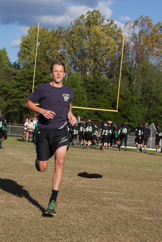 A swim-team member and student of Southwest Guilford High School sprints during a Marine Corps workout at Southwest Guilford High School in Greensboro, N.C., Oct. 23, 2013. U.S. Marine Corps Sgt. Justin Lail, a recruiter with Recruiting Sub Station Greensboro and native of Catawba, N.C., has been working with the swim team for more than three weeks using Marine Corps physical fitness techniques to improve their overall conditioning for their upcoming season. (U.S. Marine Corps photo by Sgt. Dwight A. Henderson/Released)