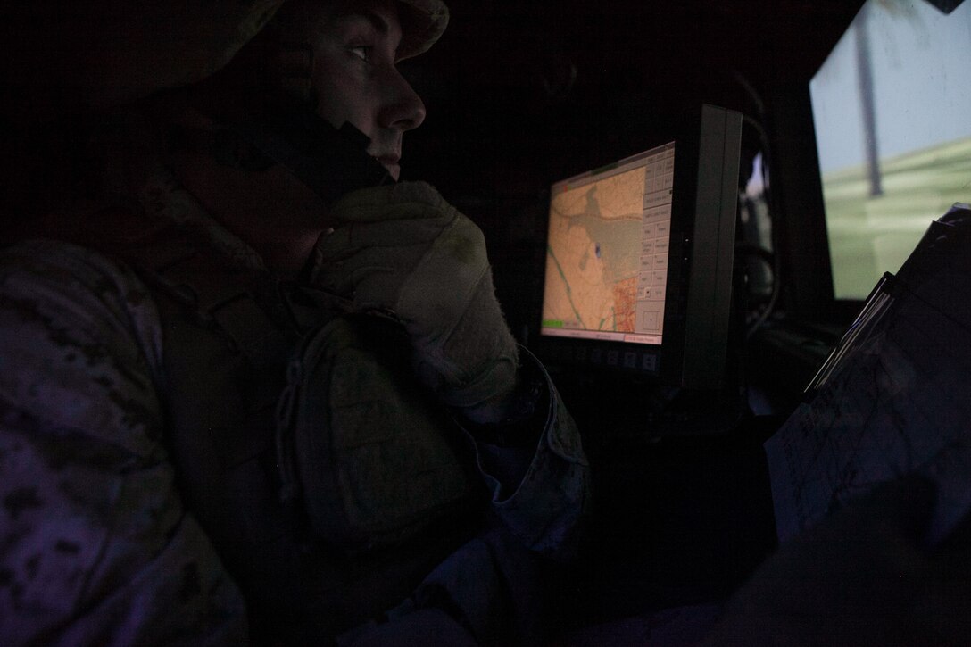 Corporal Keith A. Smith, a section leader with Combined Anti-Armor Team,  Weapons Co., Battalion Landing Team 2nd Battalion, 4th Marines, 31st Marine Expeditionary Unit, and a native of Minneapolis, Min., uses a map while positioning a Humvee during a mission in the Combat Convoy Simulator here, Oct. 29. The CCS puts the Marines in realistic situations, using recoil simulating weapon systems while maneuvering through a variety of scenarios in a combat zone. The $5.5 million training facility can simulate high value target extractions, security patrols, medical evacuations and calling for close-air support.  The 31st MEU is the Marine Corps’ force in readiness in the Asia-Pacific region and is the only continuously forward deployed MEU. 