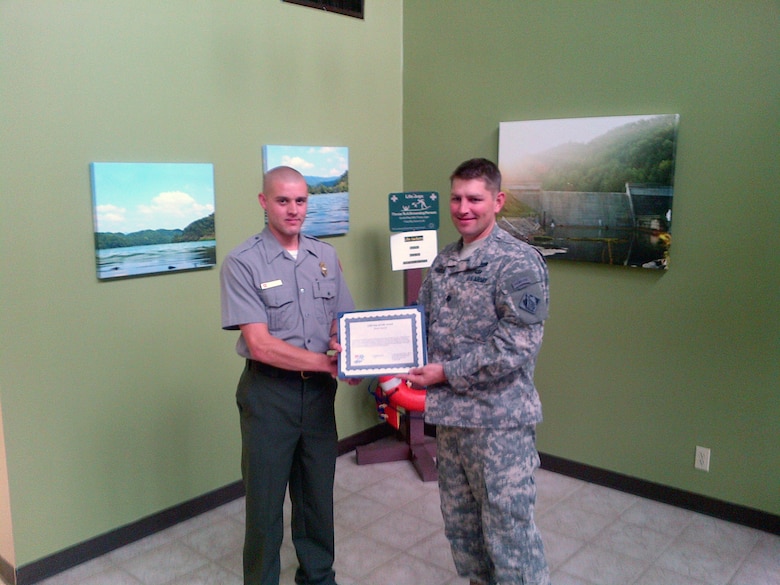 U.S. Army Corps of Engineers Nashville District Commander, Lt. Col. John Hudson presents Park Ranger Brent Sewell from Martin’s Fork Lake with the Star of Life award to Sewell for rescuing a drowning teenager from, Smith, Ky., on Sept. 1, 2013.  