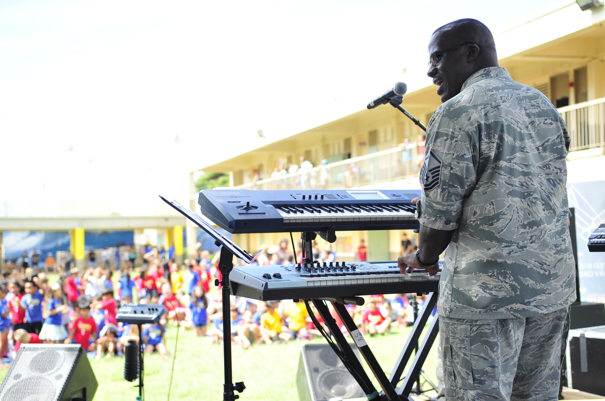 Master Sgt. Darryl McEachin, from Band of the Pacific-Hawaii's rock band, Hana Hou, performs at an elementary school Oct. 22, 2013, near Joint Base Pearl Harbor-Hickam, Hawaii. The band performed for over two thousand elementary students at Kaleiopuu and Wailua Elementary schools on Sept. 25, and Oct. 22, 2013. The performances were organized as part of a community outreach incentive program. (U.S. Air Force courtesy photo)  