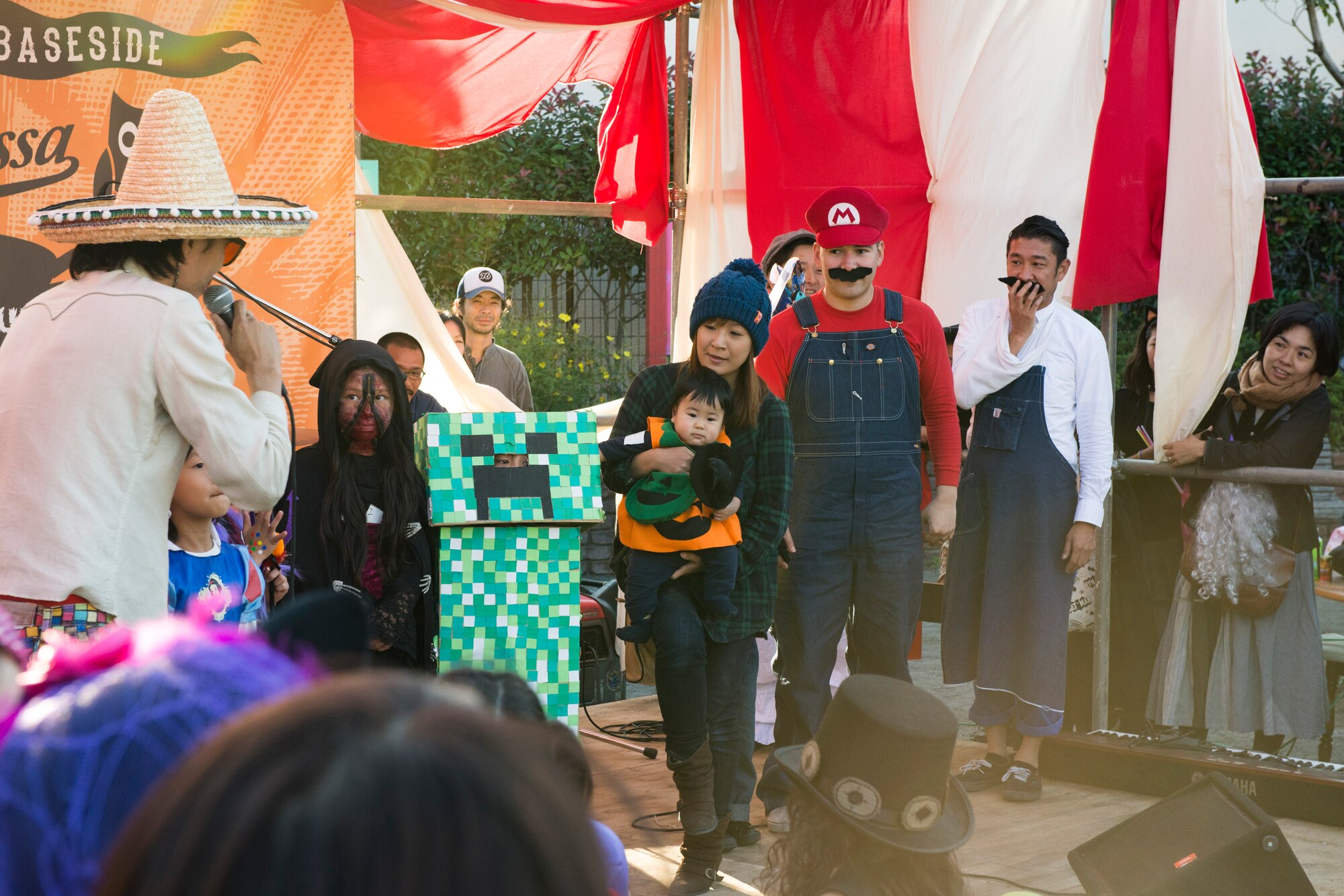 Tech. Sgt. Mario Bernudez (dressed as Mario), his wife Mitsumi and his son Kai, 4, participate in a costume contest at a Halloween festival at Fussa, Japan, Oct. 27, 2013. Dozens of Yokota Air Base members and local Japanese citizens participated in the contest and festival. (U.S. Air Force photo by Senior Airman Cody H. Ramirez)