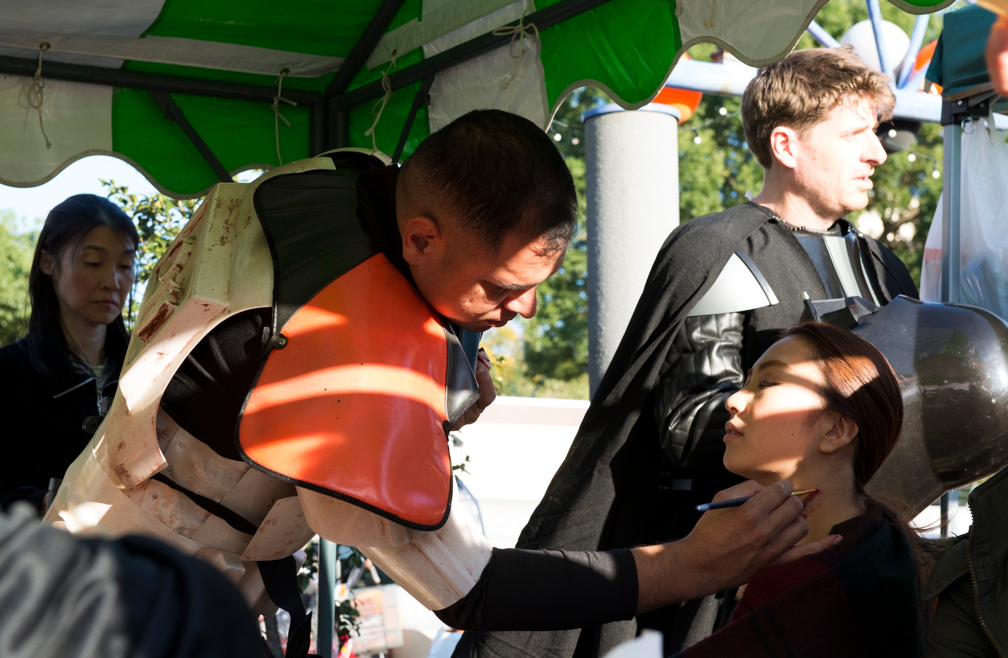 A Yokota Air Base community member paints a scar onto a local citizen’s neck in Fussa, Japan, Oct. 27, 2013. Every year, Halloween is celebrated by Yokota and the local community. (U.S. Air Force photo by Senior Airman Cody H. Ramirez)