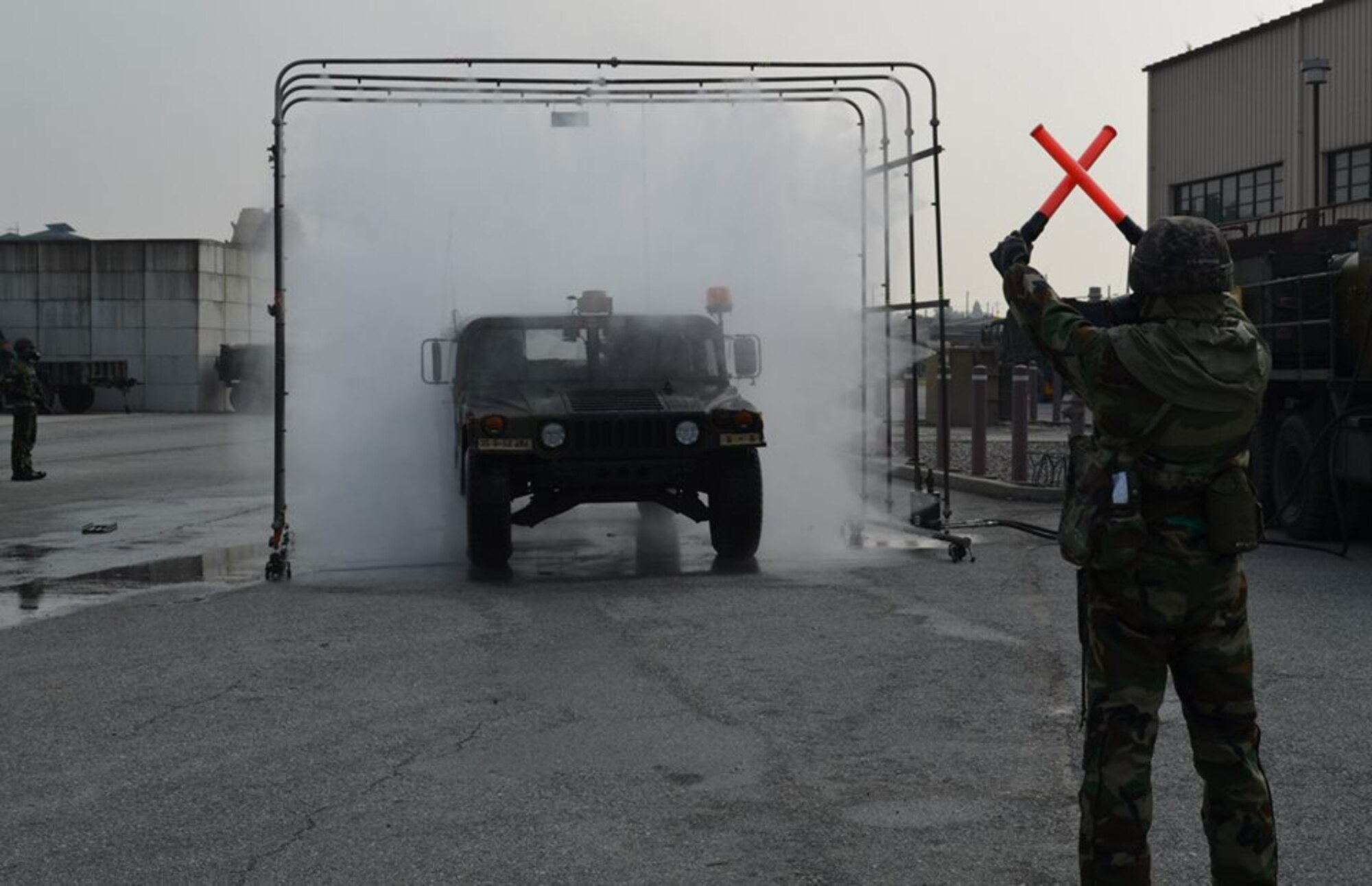OSAN AIR BASE -- Soldiers with the 35th Air Defense Artillery brigade and Republic of Korean Air Force counterparts operate a nuclear, biological and chemical decontamination exercise during the Dragon brigade's field training exercise here, Oct. 24. (U.S. Army Photo by Spc. Shawn Denham, PAO, 35th ADA)
