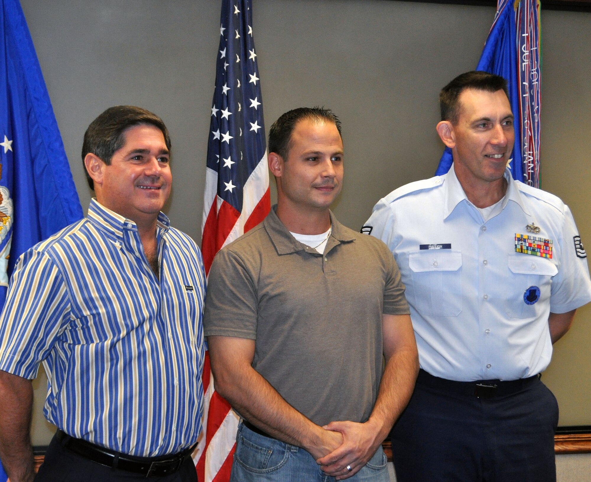 TRAVIS AIR FORCE BASE, Calif. -- Air Force reservist, Joshua S. Millay, poses for a picture with his friend and mentor, retired Col. Barrett Broussard, and his recruiter, Tech. Sgt. Wiliam Pullion Oct. 21. (U.S. Air Force photo/Ellen Hatfield)