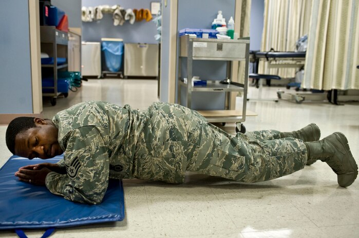 Staff Sgt. Corey Terrell, 99th Security Forces Squadron response force member, performs a plank during the second annual occupational and physical therapy open house at the Mike O'Callaghan Federal Medical Center Oct. 29, 2013, at Nellis Air Force Base, Nev. Participants were timed to see who could hold a plank the longest to win a gift card as a prize. (U.S. Air Force photo by Senior Airman Matthew Lancaster)
