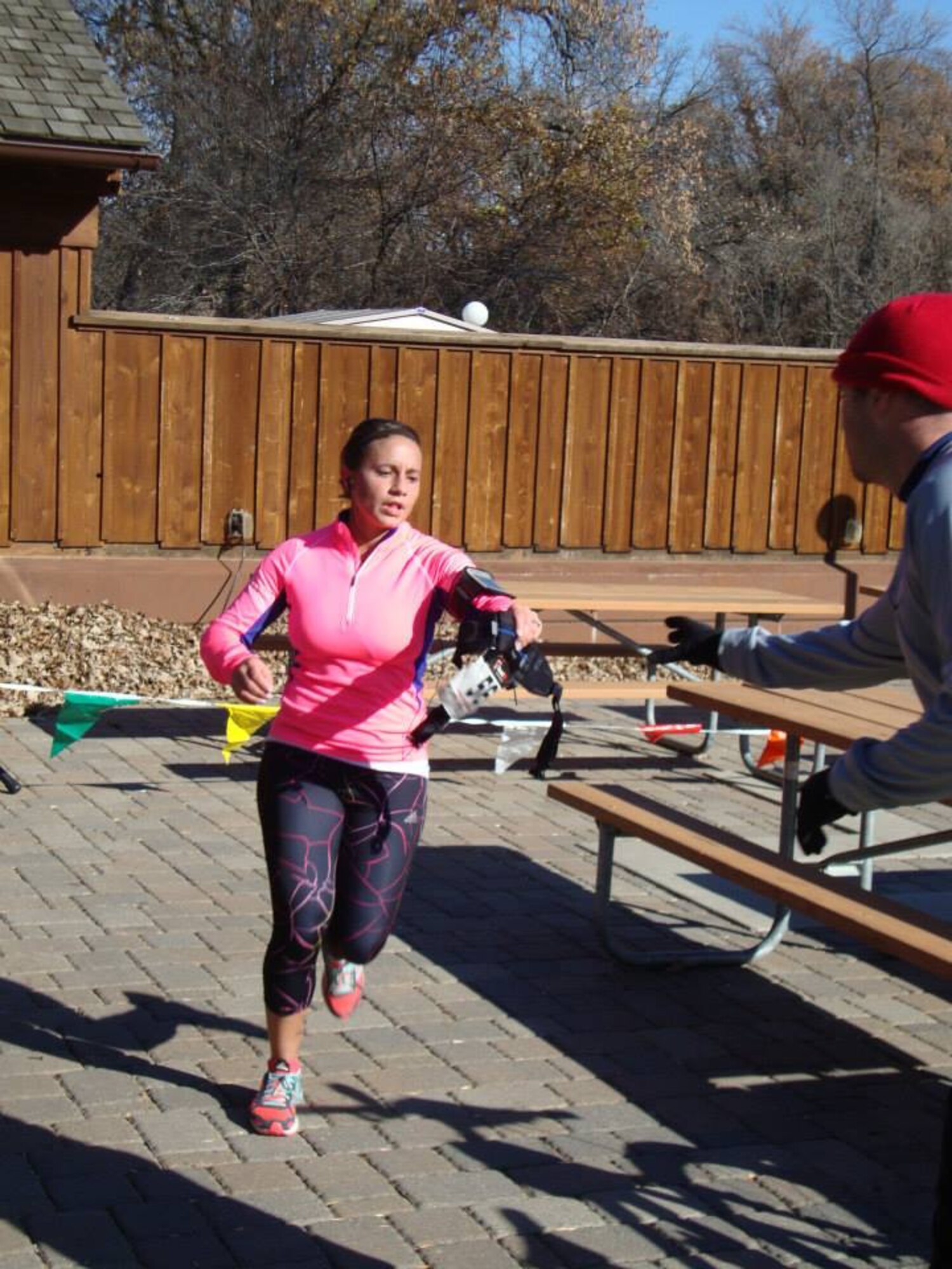 Airman 1st Class Olivia Minks hands off the belt with the tag number to Senior Airman Jeffrey Lowder during the Extreme North Dakota's Terrifying Run Amongst Innumerable Lost Souls, held Oct. 27, 2013, at Turtle River State Park in Arvilla, N.D. Minks was part of a four-person team that placed third overall in the relay team category of the endurance race. (Courtesy photo)