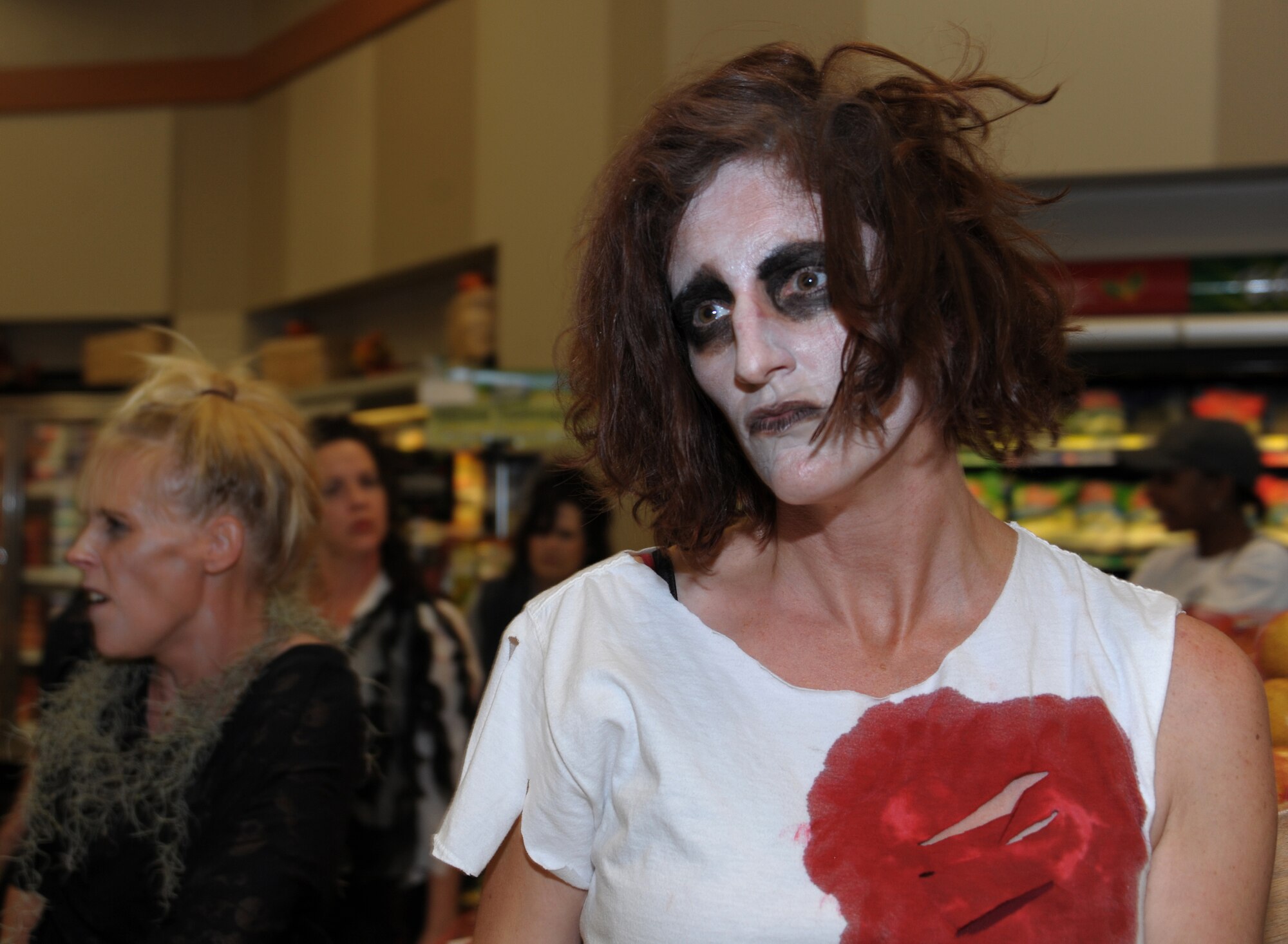 MAXWELL AIR FORCE BASE, Ala. -- A member of the Maxwell-Gunter Officers' Spouses' Club dances to Michael Jackson's ‘Thriller’ Oct. 30, 2013, at the commissary. The spouses got together to perform the dance as a flash-mob to surprise unsuspecting customers as they shopped. Before the dance began they acted as normal customers shopping in various aisles of the store. (U.S. Air Force photo by Senior Airman Natasha Stannard/Released)