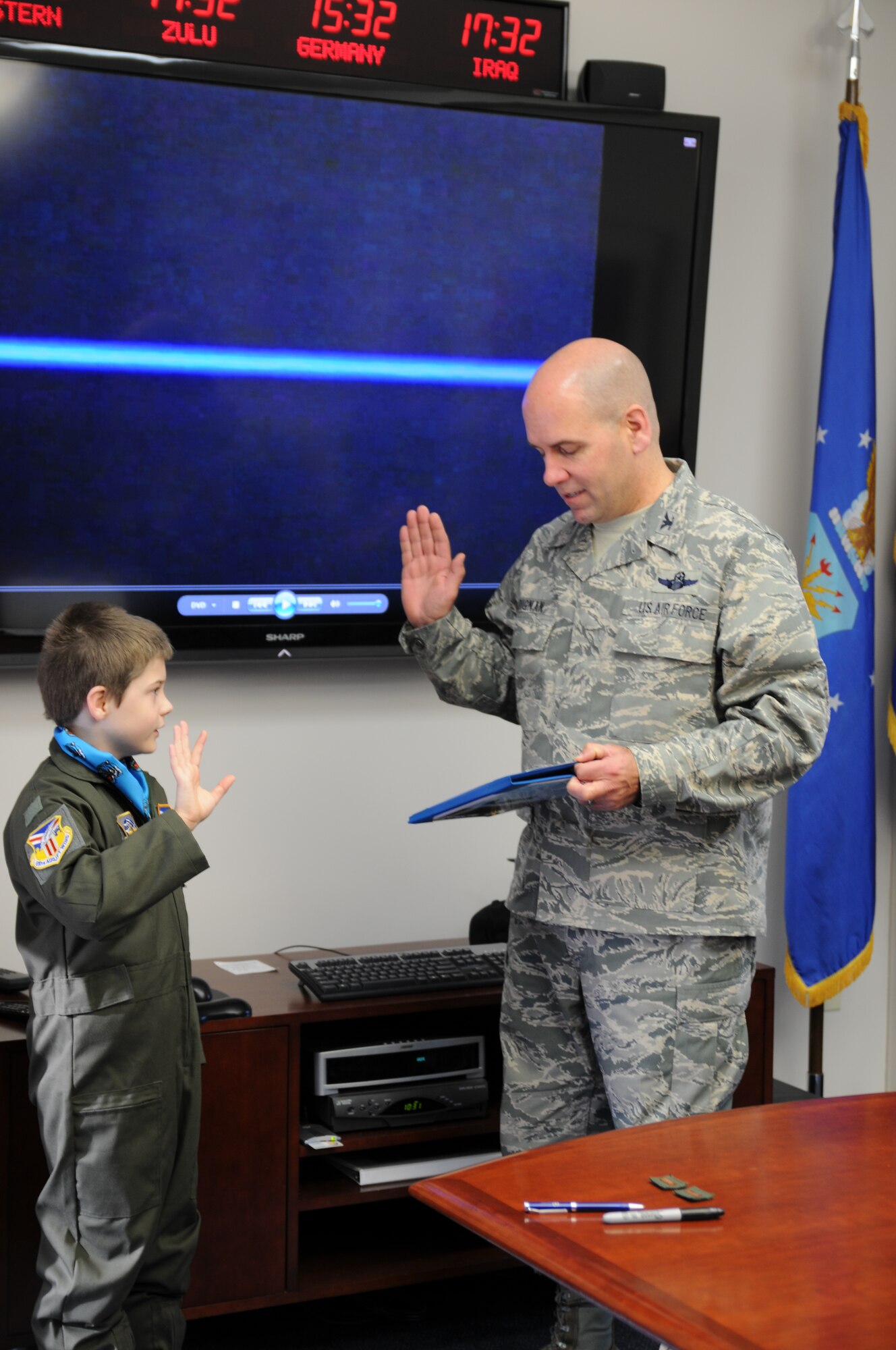 910th Airlift Wing Commander Colonel James D. Dignan (right), conducts the oath of enlistment with Bruce Cellars (left), here, Oct. 30, 2013. Bruce came to Youngstown Air Reserve Station where he was enlisted as the 56th Pilot for a Day and an honorary 2nd Lieutenant. Bruce’s day included a base tour, high-speed taxi down the flight strip in a C-130H Hercules aircraft, a tour of the base fire department that included the chance to control a crash response truck water cannon and escort service in a Marine Corps Humvee, provided by the Marine Corps Reserve center here. The 910th Airlift Wing pilot for a day program began in 2000 to help bring a ray of sunshine into the lives of children being treated for chronic or life threatening conditions. U.S. Air Force photo by Mr. Eric M. White