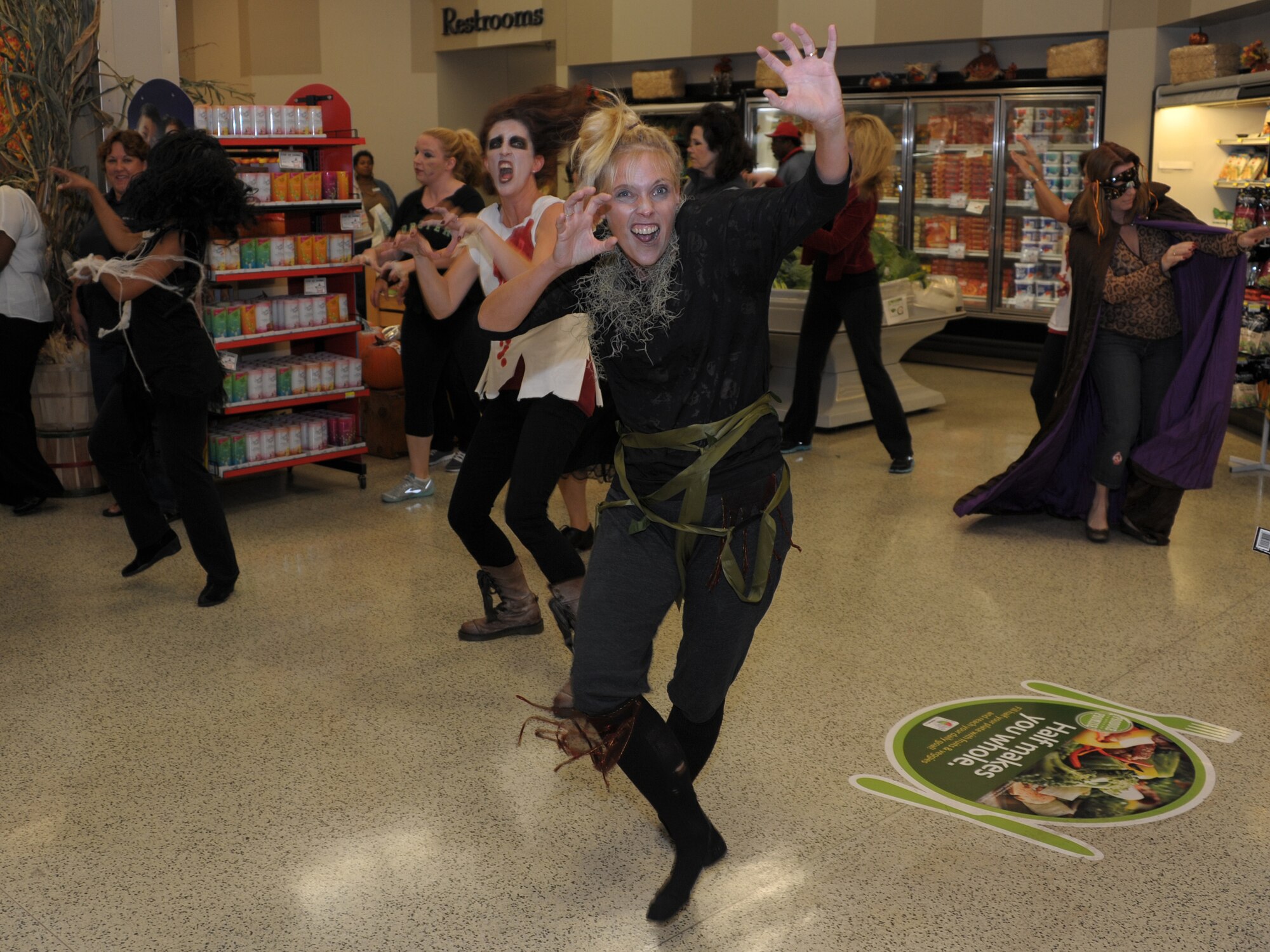 MAXWELL AIR FORCE BASE, Ala. -- Members of the Maxwell-Gunter Officers' Spouses' Club dance to Michael Jackson's ‘Thriller’ Oct. 30, 2013, at the commissary. The spouses got together to perform the dance as a flash-mob to surprise unsuspecting customers as they shopped. (U.S. Air Force photo by Senior Airman Natasha Stannard/Released)