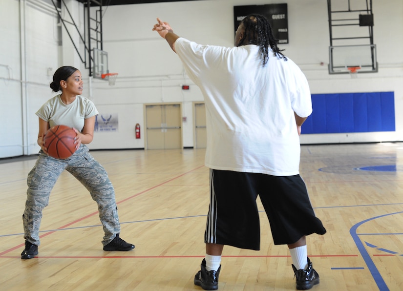 Airman 1st Class Alissa Bolar, 744th Communications Squadron, Freedom of Information Act manager, plays basketball with members of the Prince George County Special Olympics team at the West Fitness Center at Joint Base Andrews, Md., on Oct. 30, 2013. The event was held in recognition of National Disability Employment Awareness Month observed in November. (U.S. Air Force photo/Airman 1st Class Joshua R. M. Dewberry)