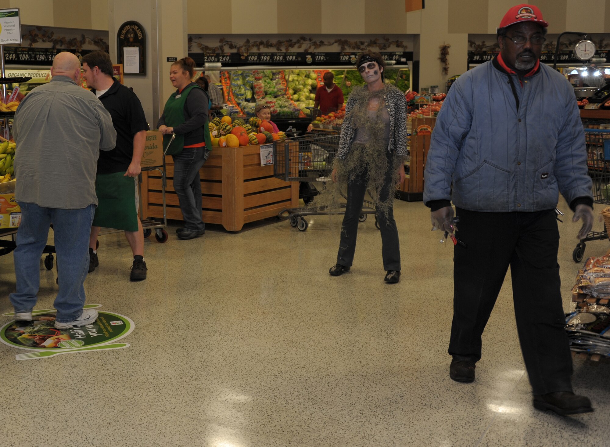 MAXWELL AIR FORCE BASE, Ala. -- A Member of the Maxwell-Gunter Officers' Spouses' Club walks through the commissary in zombie attire Oct. 30, 2013. The spouses got together to perform a flash-mob performance of Michael Jackson's ‘Thriller’ to surprise customers as they shopped. (U.S. Air Force photo by Senior Airman Natasha Stannard/Released)