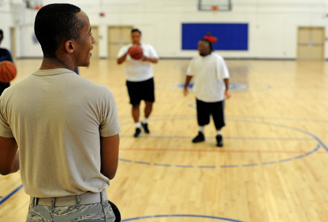 Anthony Sledge, 459th Operations Support Squadron knowledge operations manager, plays basketball with members of the Prince George County Special Olympics team at the West Fitness Center at Joint Base Andrews, Md., on Oct. 30, 2013. The event was held in recognition of National Disability Employment Awareness Month observed in November.  (U.S. Air Force photo/Airman 1st Class Joshua R. M. Dewberry)